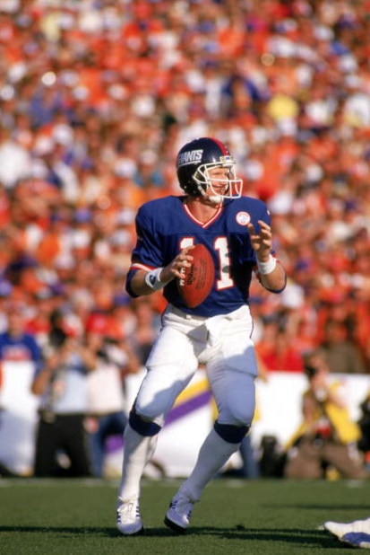 PASADENA, CA - JANUARY 25:  Quarterback Phil Simms #11 of the New York Giants drops back to pass against the Denver Broncos during Super Bowl XXI at the Rose Bowl on January 25, 1987 in Pasadena, California. The Giants defeated the Broncos 39-20. (Photo b