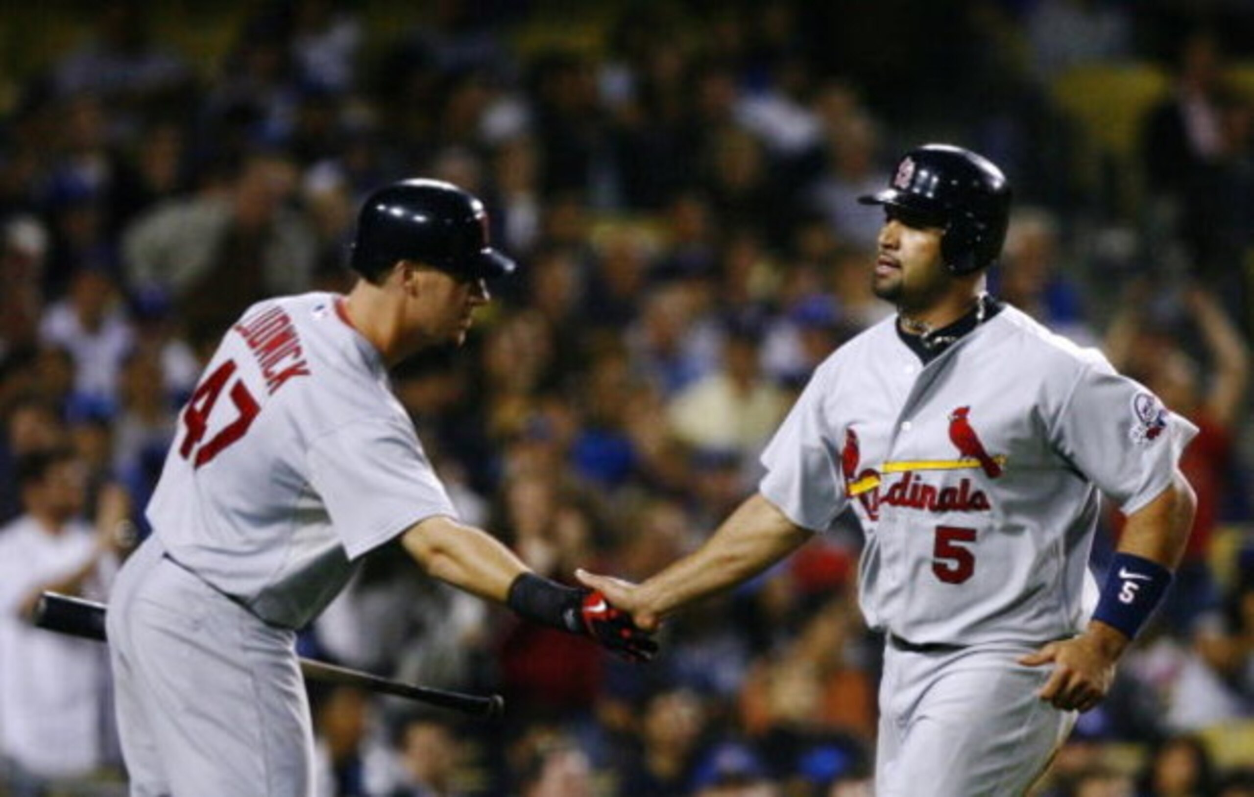 LOS ANGELES, CA - AUGUST 19:  Albert Pujols #5 (L) of the St. Louis Cardinals celebrates with teammate Ryan Ludwick #47 after scorning in the ninth inning against the Los Angeles Dodgers at Dodger Stadium on August 19, 2009 in Los Angeles, California.  (P