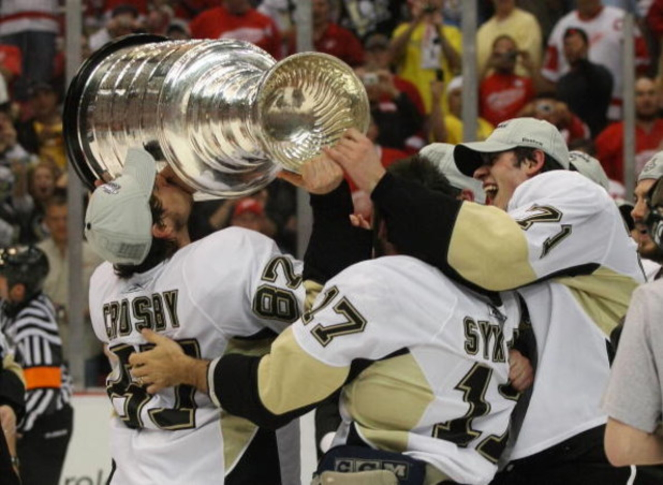 DETROIT - JUNE 12: (L-R) Sideny Crosby #87, Petr Sykora #17 and Evgeni Malkin #71 of the Pittsburgh Penguins hold  the Stanley Cup following the Penguins victory over the Detroit Red Wings in Game Seven of the 2009 NHL Stanley Cup Finals at Joe Louis Aren