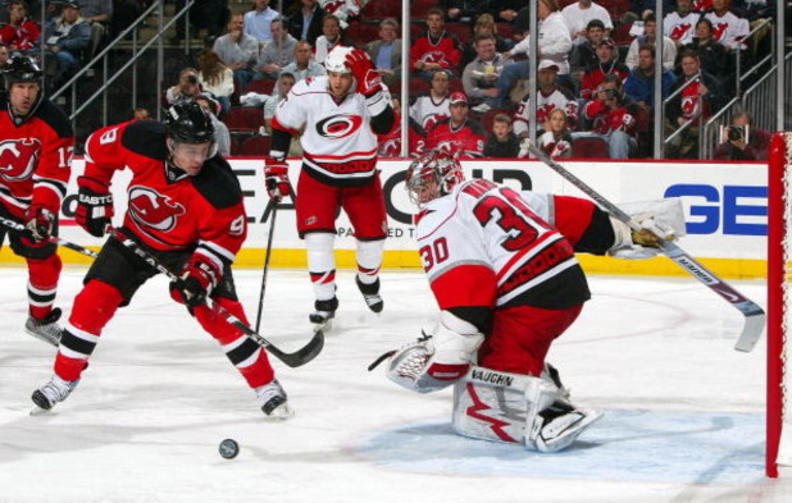 NEWARK, NJ - APRIL 23:  Cam Ward #30 of the Carolina Hurricanes denies a scoring chance by Zach Parise #9 of the New Jersey Devils during Game Five of the Eastern Conference Quarterfinal Round of the 2009 NHL Stanley Cup Playoffs on April 23, 2009 at the 