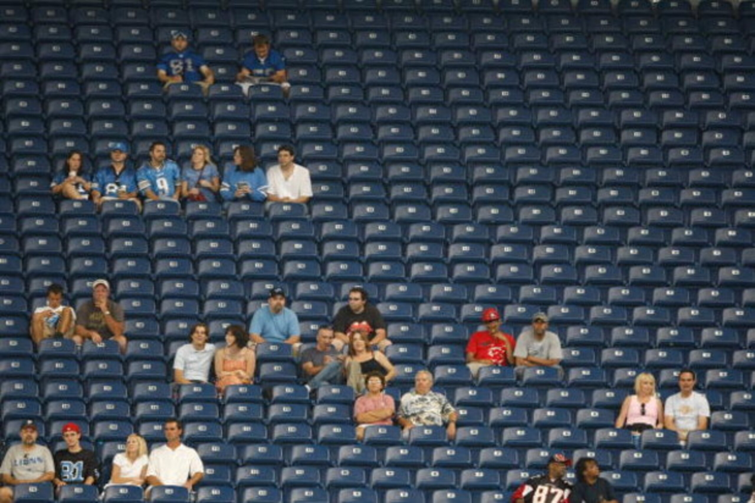 DETROIT, MI - AUGUST 15: Fans are surrounded by empty seats during the game between the Atlanta Falcons against the Detroit Lions at Ford Field on August 15, 2009 in Detroit, Michigan. (Photo by Scott Boehm/Getty Images)