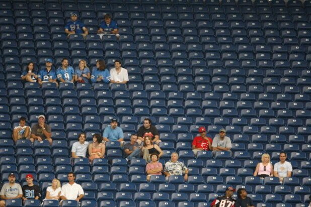 DETROIT, MI - AUGUST 15: Fans are surrounded by empty seats during the game between the Atlanta Falcons against the Detroit Lions at Ford Field on August 15, 2009 in Detroit, Michigan. (Photo by Scott Boehm/Getty Images)