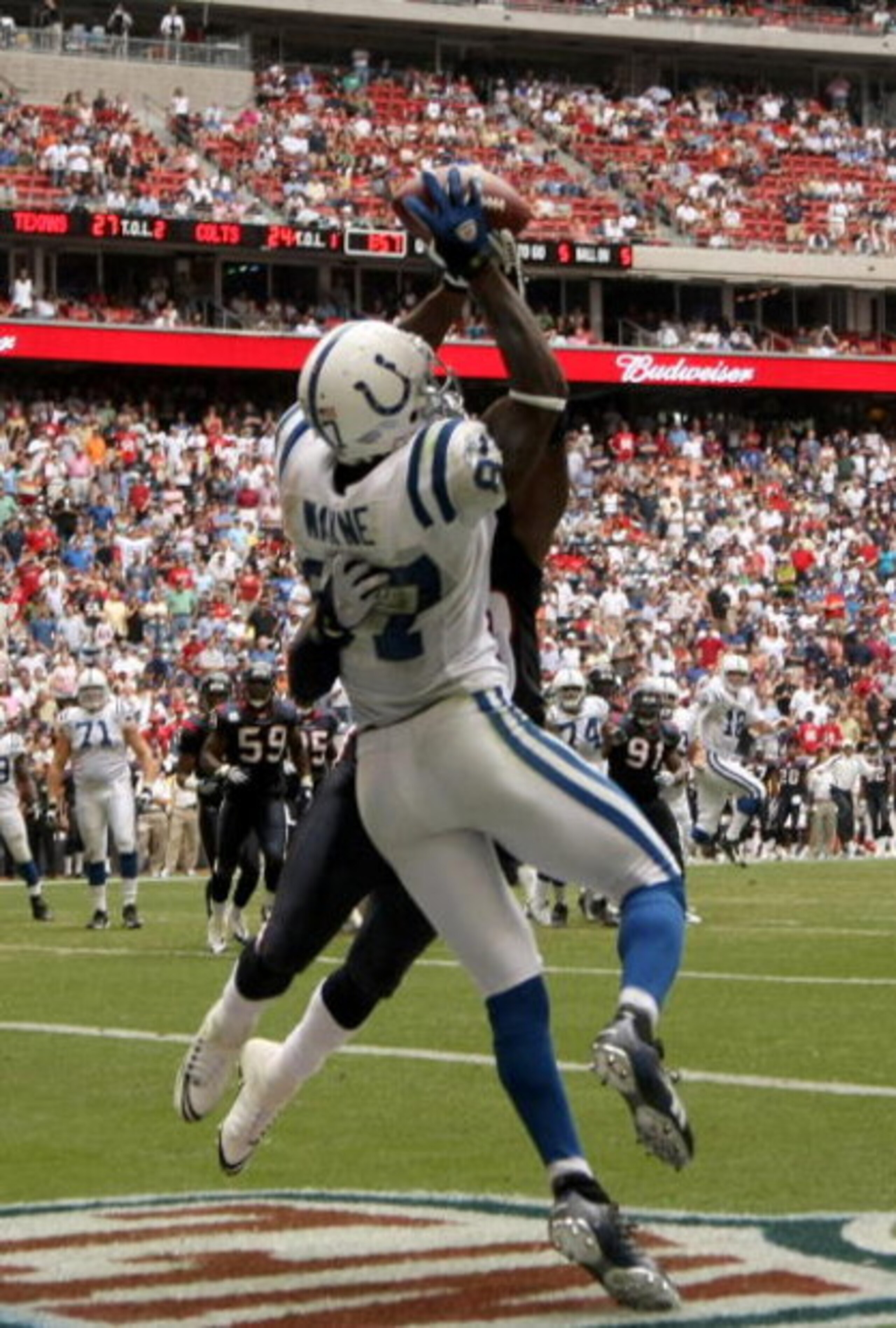 HOUSTON - OCTOBER 05:  Wide receiver Reggie Wayne #87 of the Indianapolis Colts catches the winning touchdown pass with one minute fifty four seconds remaining in the game over cornerback Jacques Reeves #35 of the Houston Texans on October 5, 2008 at Reli