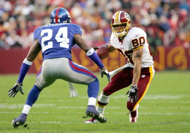 LANDOVER, MD - DECEMBER 5: Receiver Laveraneus Coles #80 of the Washington Redskins makes a reception as Will Peterson #24 of the New York Giants defends during the first half of the game at Fed Ex Field on December 5, 2004 in Landover, Maryland.  (Photo 