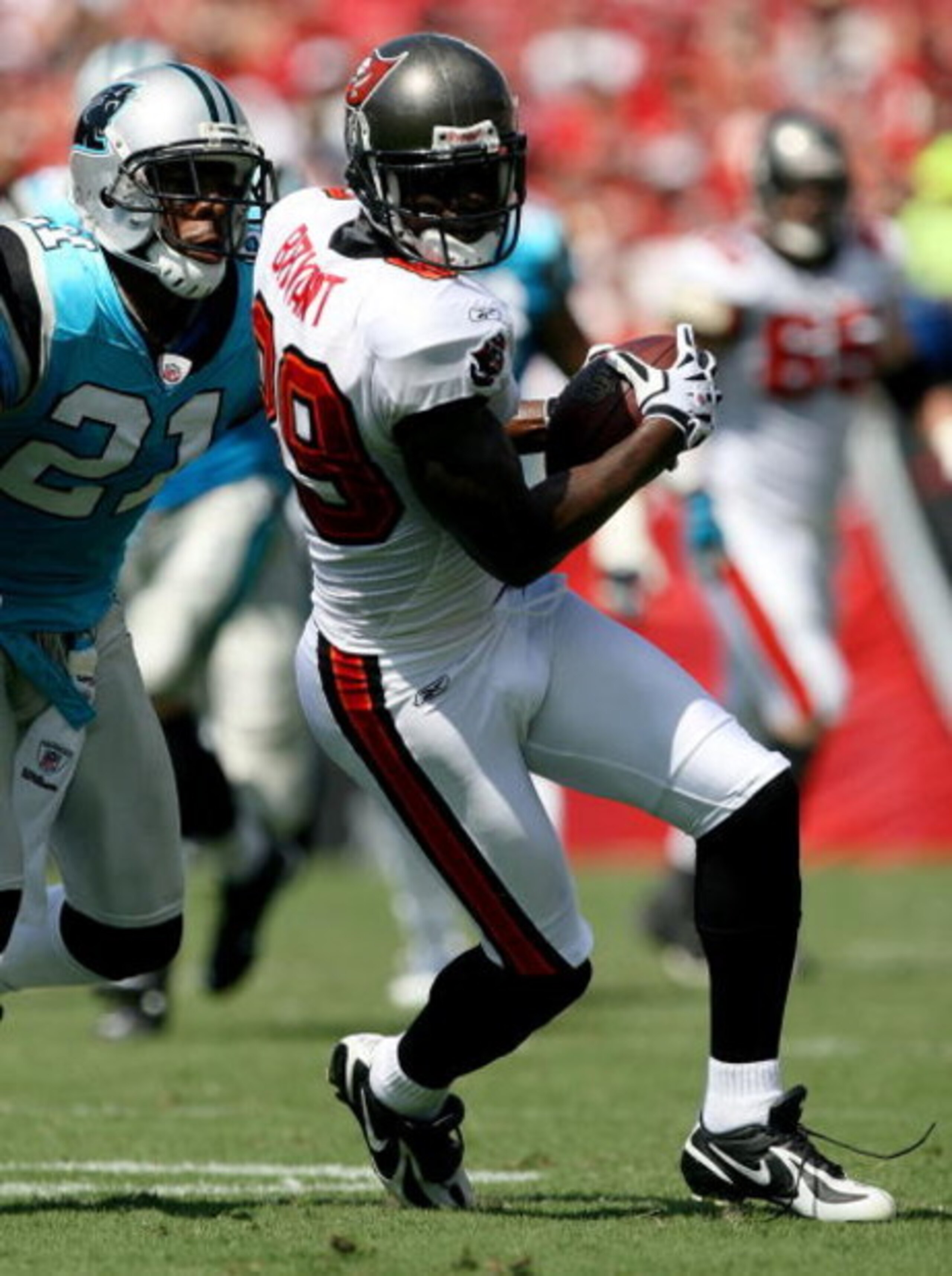 TAMPA, FL - OCTOBER 12:  Wide receiver Antonio Bryant #89 of Tampa Bay Buccaneers looks for room to run while avoiding a tackle attempt by cornerback Ken Lucas #21 of the Carolina Panthers at Raymond James Stadium on October 12, 2008 in Tampa, Florida.  (