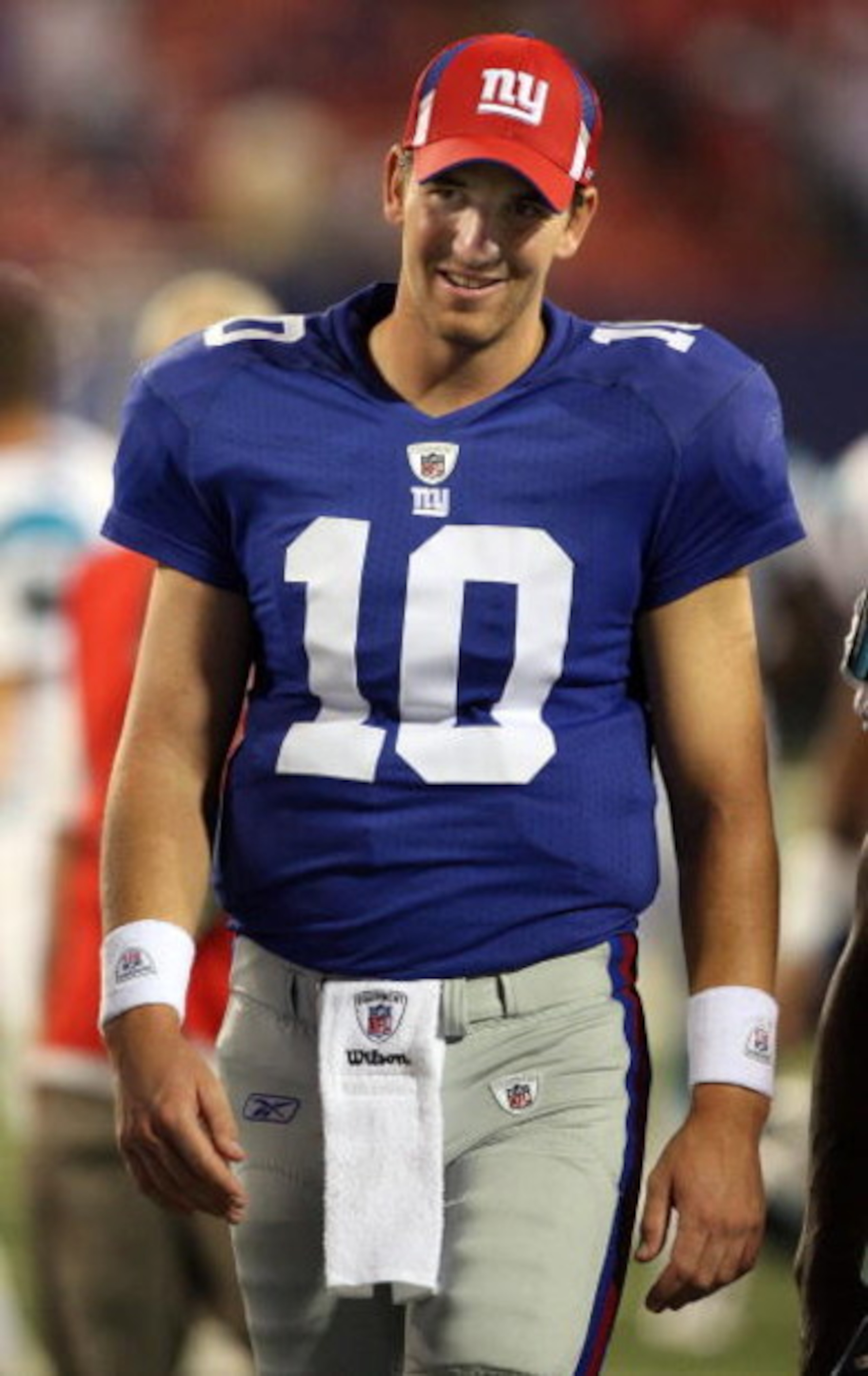 EAST RUTHERFORD, NJ - AUGUST 17:  Eli Manning #10 of the New York Giants walks off the field after a preseason NFL game against the Carolina Panthers on August 17, 2009 at Giants Stadium in East Rutherford, New Jersey. The Giants defeated the Panthers 24-