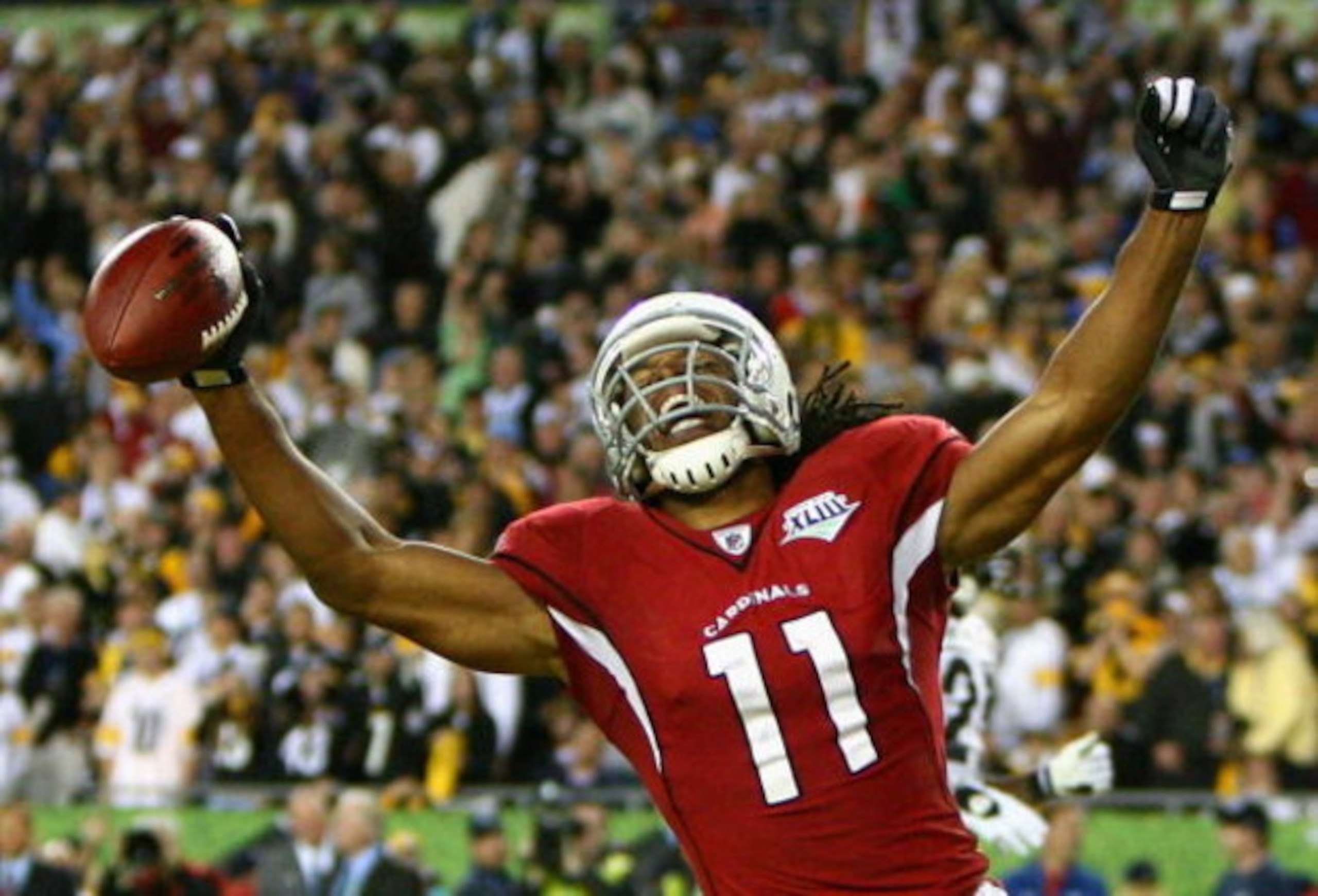TAMPA, FL - FEBRUARY 01:  Larry Fitzgerald #11 of the Arizona Cardinals celebrates after scoring a touchdown in the fourth quarter against the Pittsburgh Steelers during Super Bowl XLIII on February 1, 2009 at Raymond James Stadium in Tampa, Florida.  (Ph