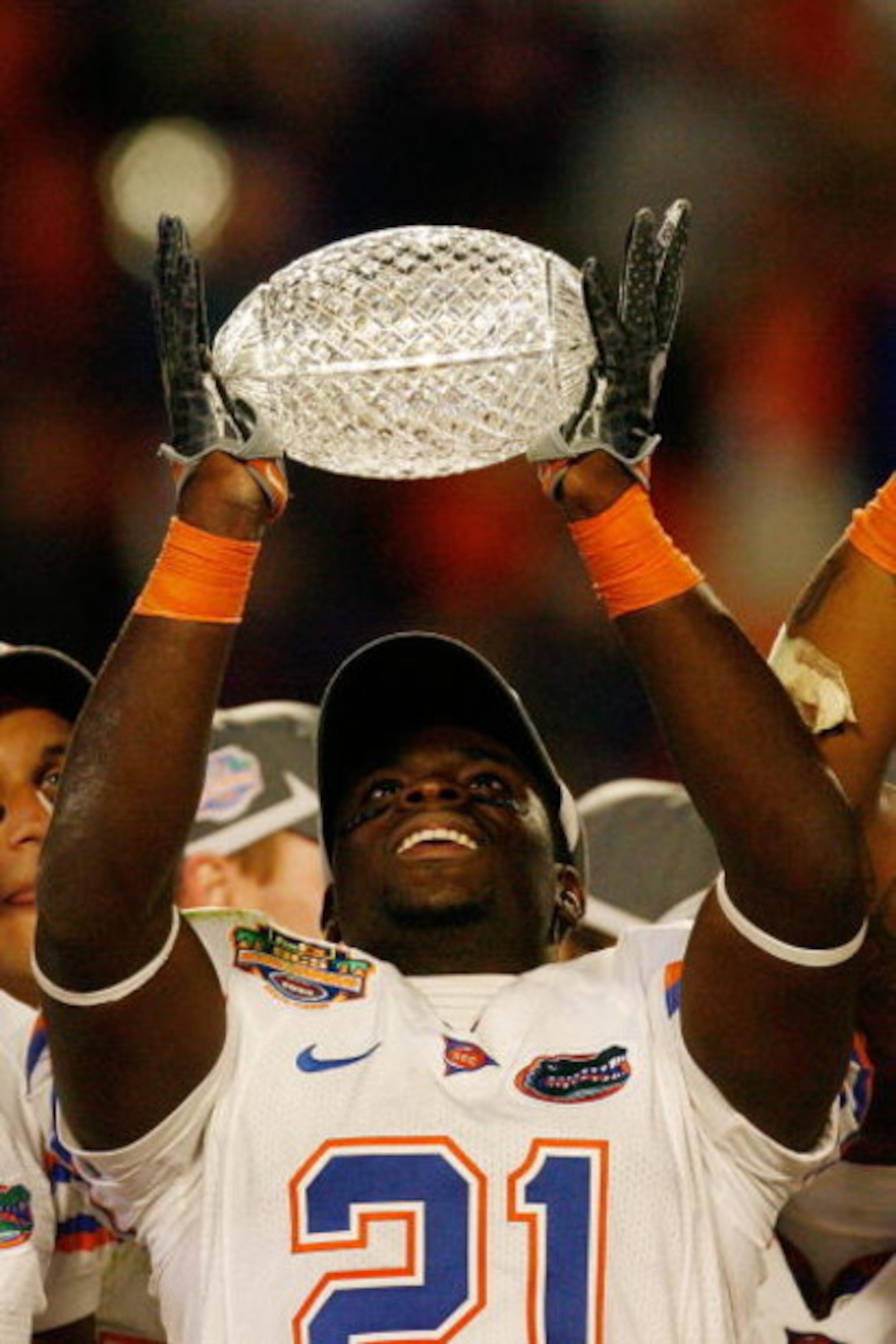 MIAMI - JANUARY 08:  Major Wright #21 and the Florida Gators celebrate with the trophy after defeating the Oklahoma Sooners in the FedEx BCS National Championship Game at Dolphin Stadium on January 8, 2009 in Miami, Florida. The Gators won the game by a s
