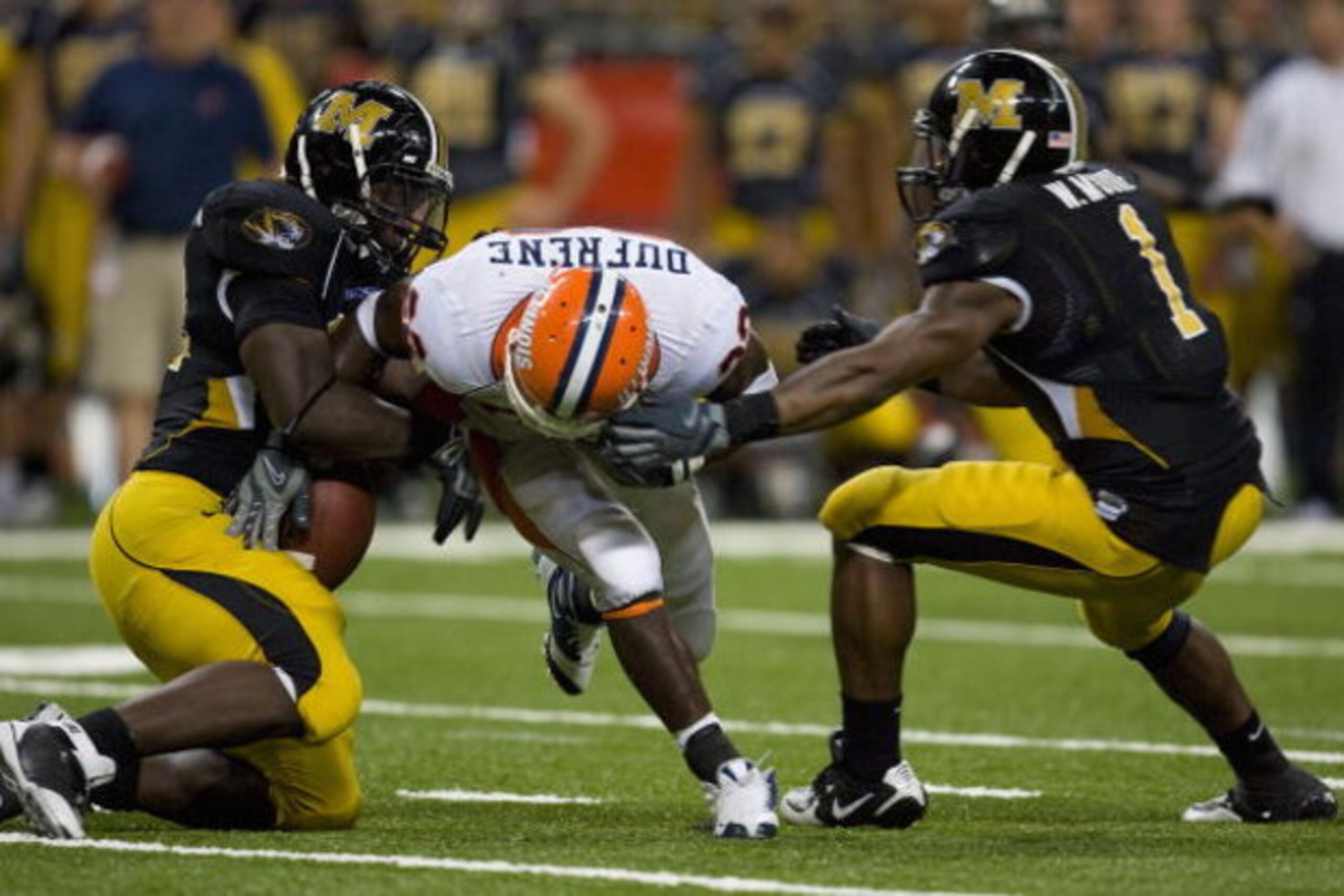 ST. LOUIS, MO - AUGUST 30:   Daniel Dufrene #22 of the University of Illinois Fighting Illini has the ball stripped by Sean Witherspoon #12 of the University of Missouri Tigers during the State Farm Arch Rivalry game at the Edward Jones Dome on August 30,