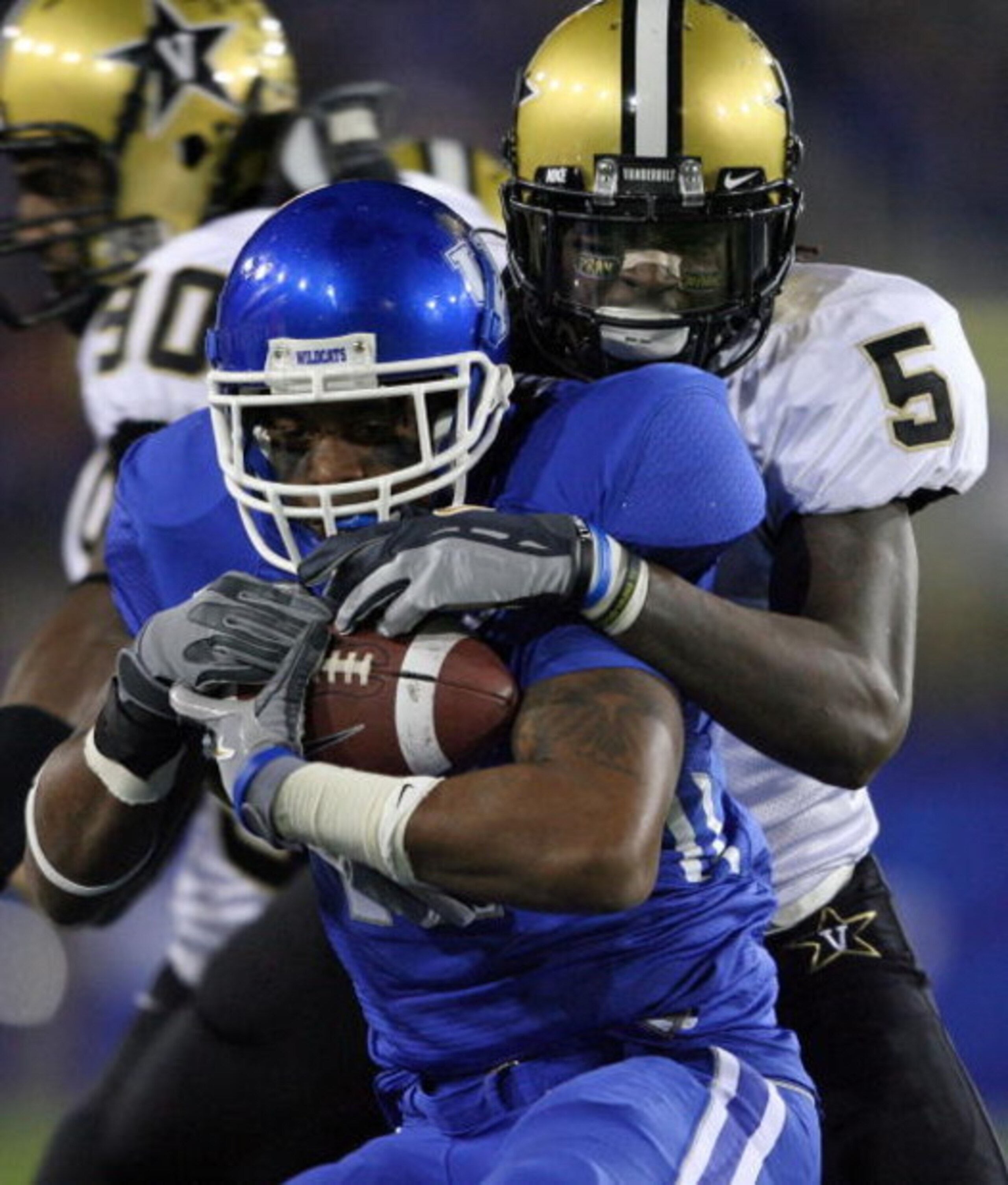 LEXINGTON, KY - NOVEMBER 15: E.J. Adams #17 of the Kentucky Wildcats is tackled by Myron Lewis #5 of the Vanderbilt Commodores during the game on November 15, 2008 at Commonwealth Stadium in Lexington, Kentucky.  (Photo by Andy Lyons/Getty Images)