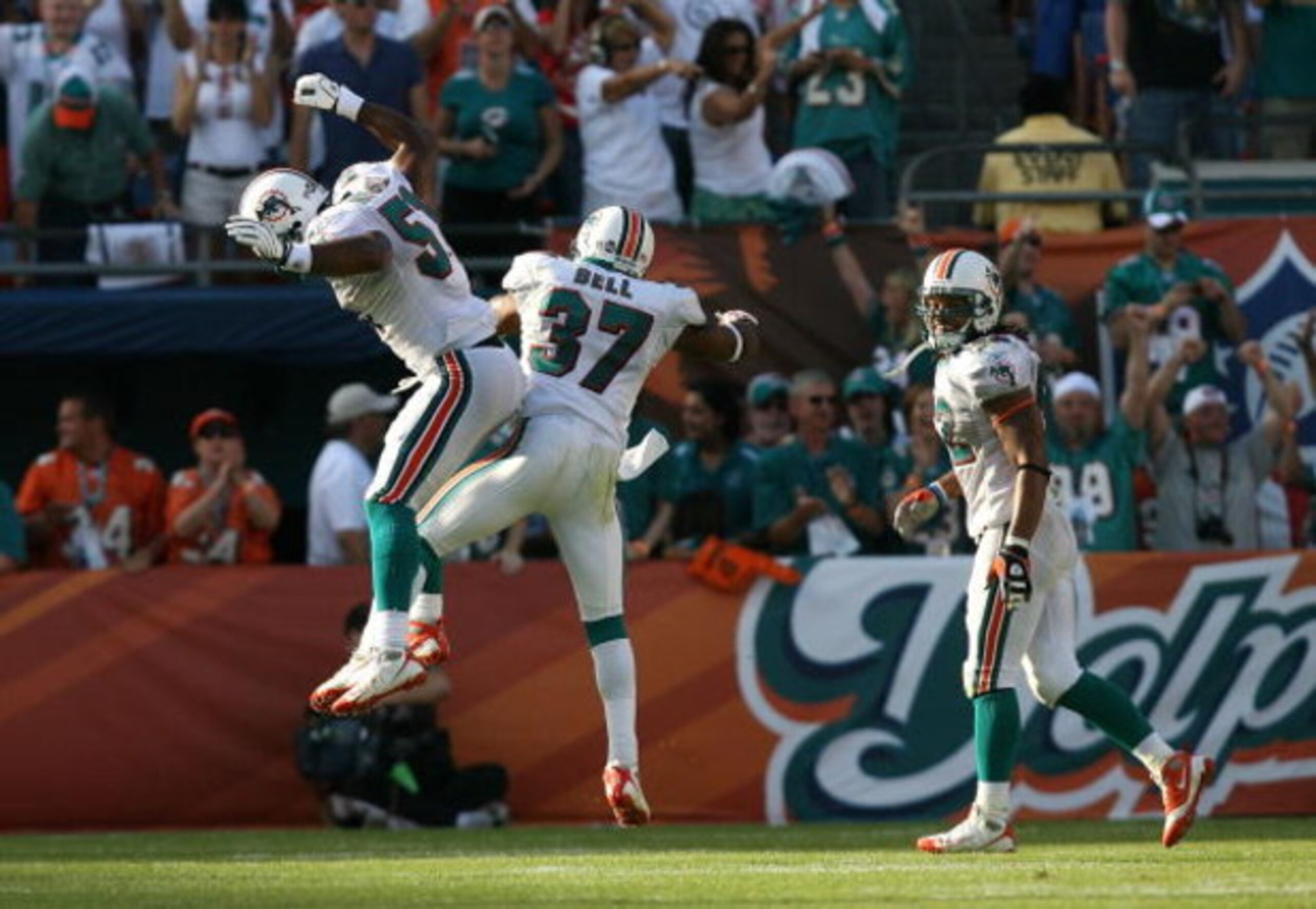 MIAMI - NOVEMBER 09:  Safety Yeremiah Bell #37 and linebacker Akin Ayodele #51 of the Miami Dolphins celebrate as linebacker Channing Crowder #52 looks on after stopping the Seattle Seahawks on a two-point conversion attempt at Dolphin Stadium on November