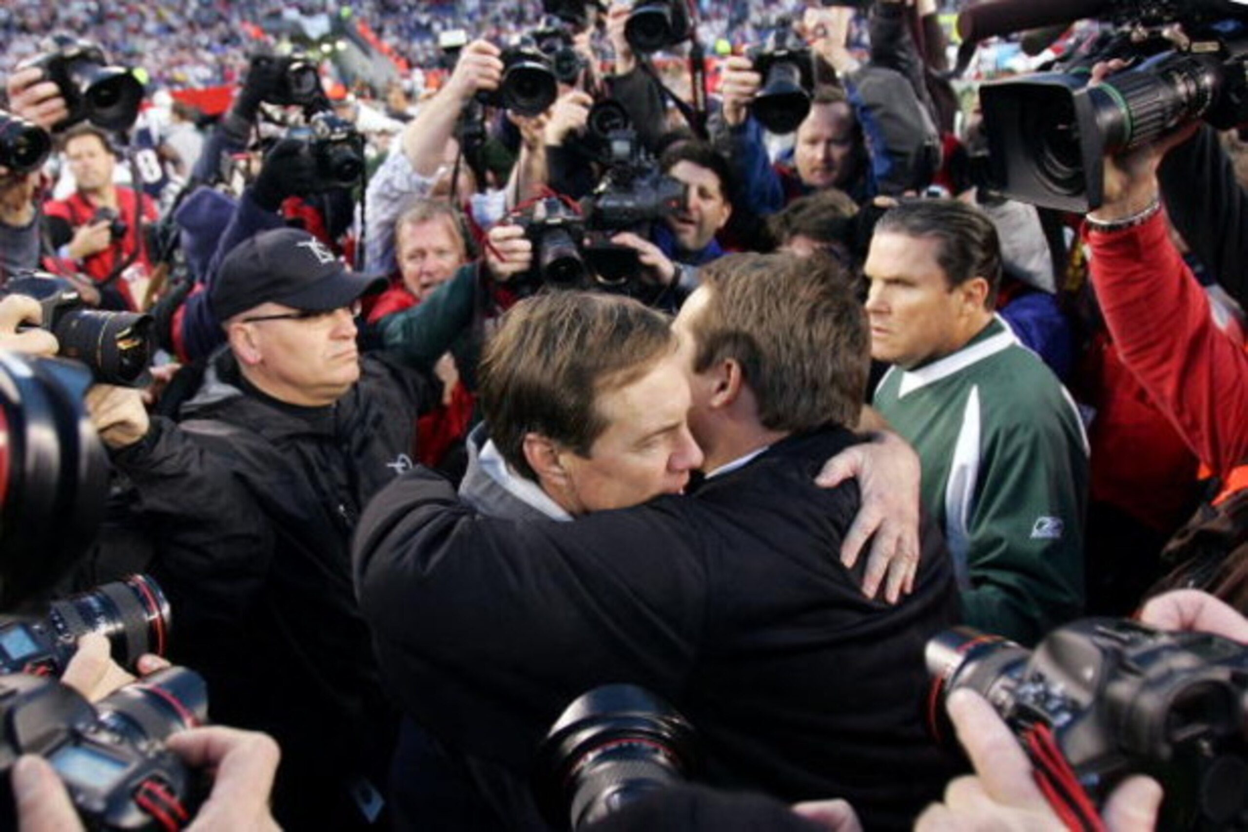 FOXBORO, MA - JANUARY 07:  Head coach Eric Mangini (R) of the New York Jets hugs head coach Bill Belichick of  the New England Patriots after their AFC Wild Card Playoff Game at Gillette Stadium on January 7, 2007 in Foxboro, Massachusetts. The Patriots w