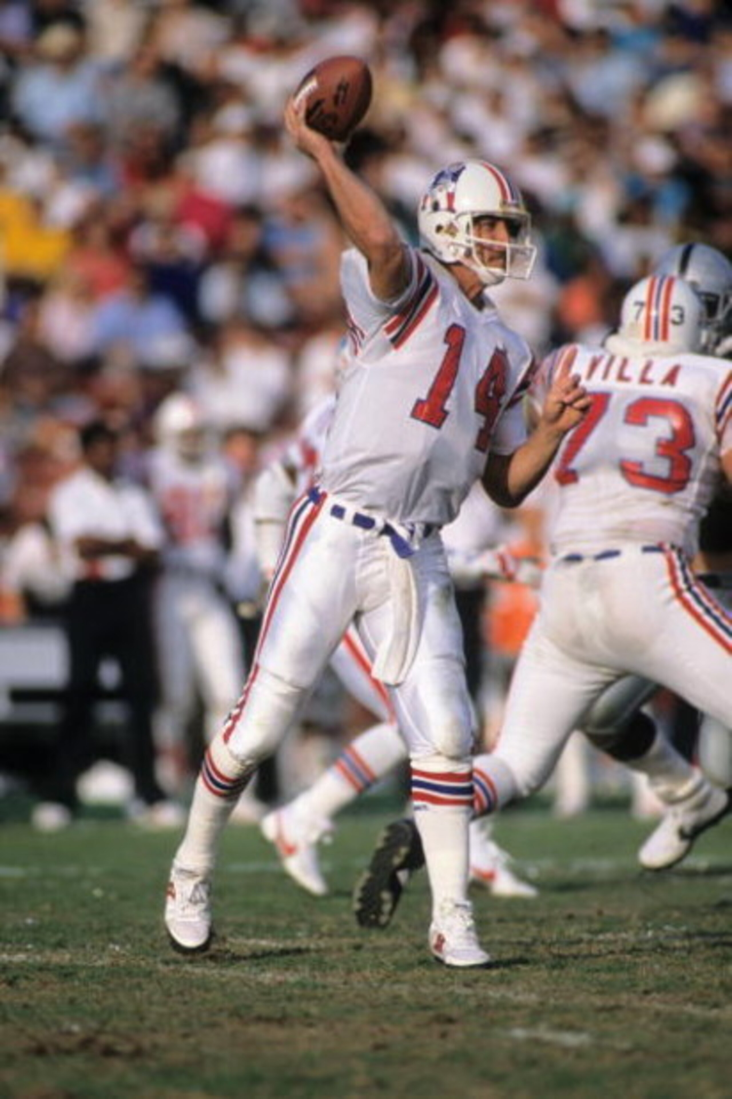 LOS ANGELES, CA - NOVEMBER 26:  Quarterback Steve Grogan #14 of New England Patriots drops back to pass during the game against the Los Angeles Raiders at the Los Angeles Memorial Coliseum on November 26, 1989 in Los Angeles, California.  The Raiders won 