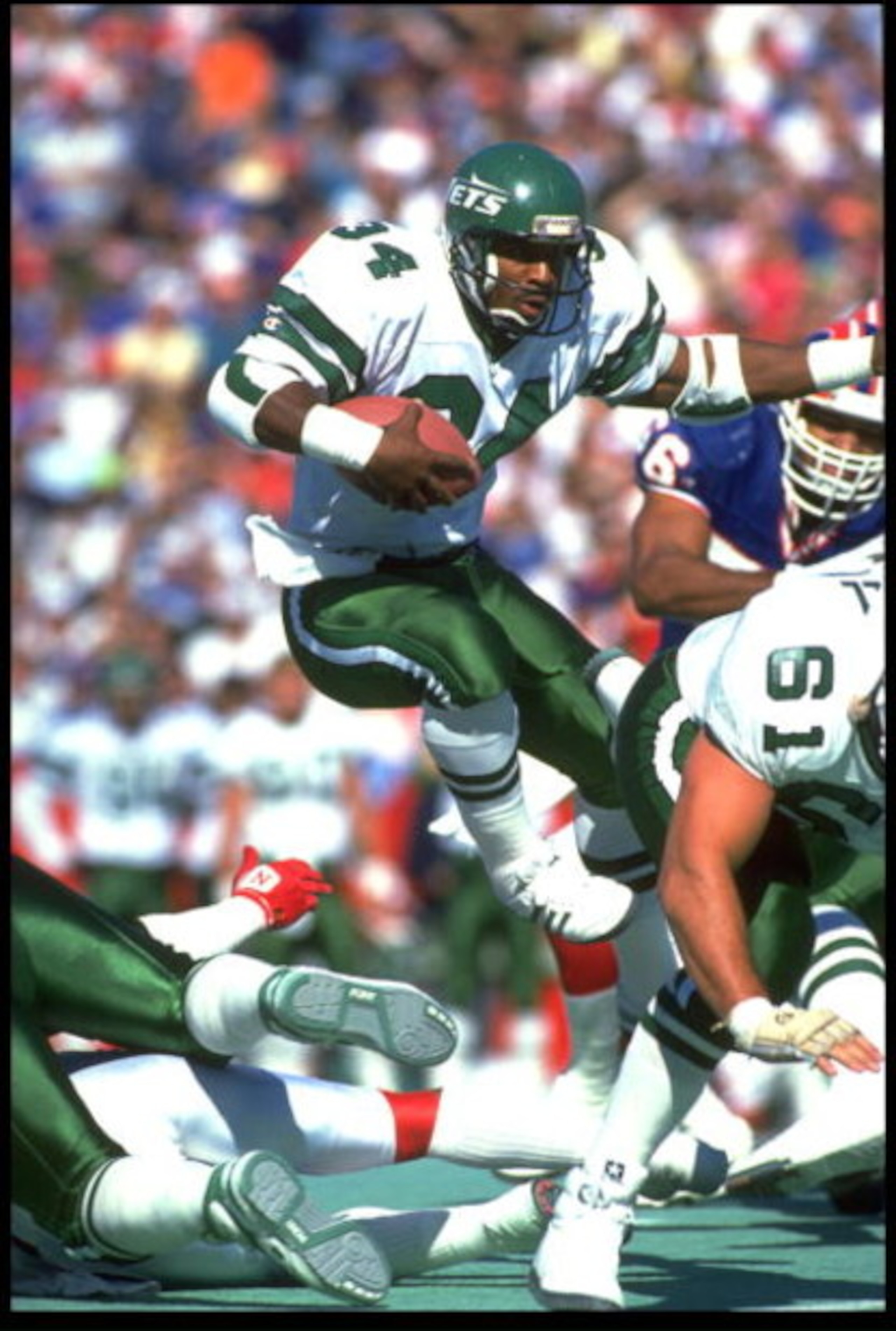 21 Oct 1991: JOHNNY HECTOR, #34, RUNNING BACK FOR THE NEW YORK JETS, LEAPS THROUGH THE LINE OF SCRIMMAGE DURING THEIR 30-27 LOSS TO THE BUFFALO BILLS AT RICH STADIUM IN ORCHARD PARK, NEW YORK.