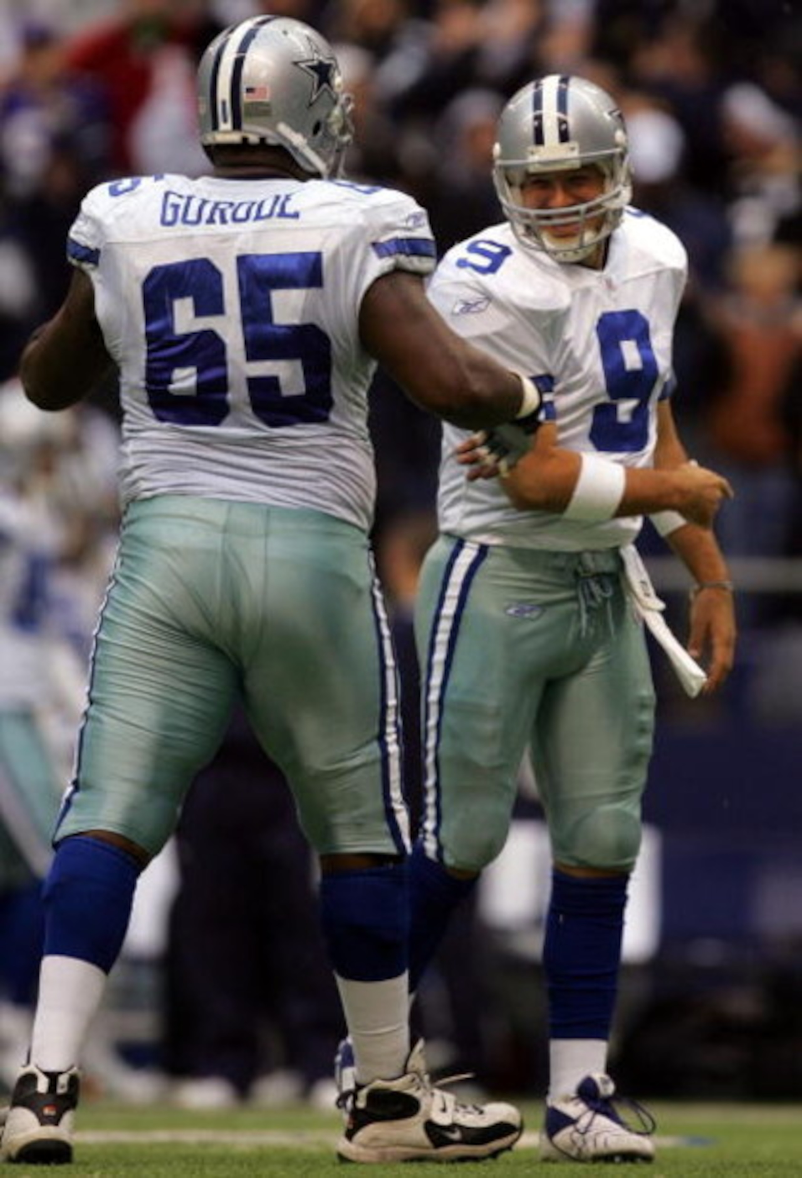 DALLAS - NOVEMBER 22: Quarterback Tony Romo #9 of the Dallas Cowboys celebrates a touchdown with teammate Andre Gurode #65 against the New York Jets in the second quarter at Texas Stadium November 22, 2007 in Irving, Texas. (Photo by Ronald Martinez/Get DALLAS - NOVEMBER 22: Quarterback Tony Romo #9 of the Dallas Cowboys celebrates a touchdown with teammate Andre Gurode #65 against the New York Jets in the second quarter at Texas Stadium November 22, 2007 in Irving, Texas. (Photo by Ronald Martinez/Get