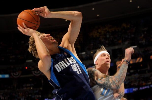 DENVER - MAY 13:  Dirk Nowitzki #41 of the Dallas Mavericks is fouled by Chris Andersen #11 of the Denver Nuggets as he sinks a shot and enroute to a three-point play in Game Five of the Western Conference Semifinals during the 2009 NBA Playoffs at Pepsi 