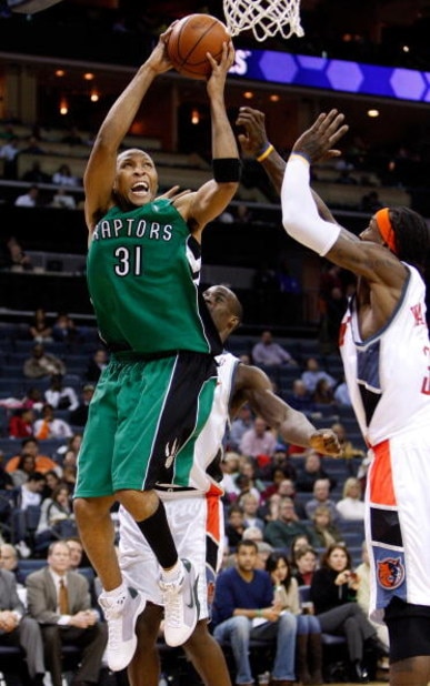 CHARLOTTE, NC - MARCH 16:  Shawn Marion #31 of the Toronto Raptors goes to the basket against teammates Emeka Okafor #50 and Gerald Wallace #3 of the Charlotte Bobcats at Time Warner Cable Arena on March 16, 2009 in Charlotte, North Carolina.  NOTE TO USE