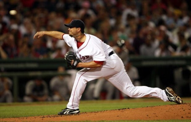 BOSTON - AUGUST 23:  Josh Beckett #19 of the Boston Red Sox delivers a pitch against the New York Yankees on August 23, 2009 at Fenway Park in Boston, Massachusetts.  (Photo by Elsa/Getty Images)