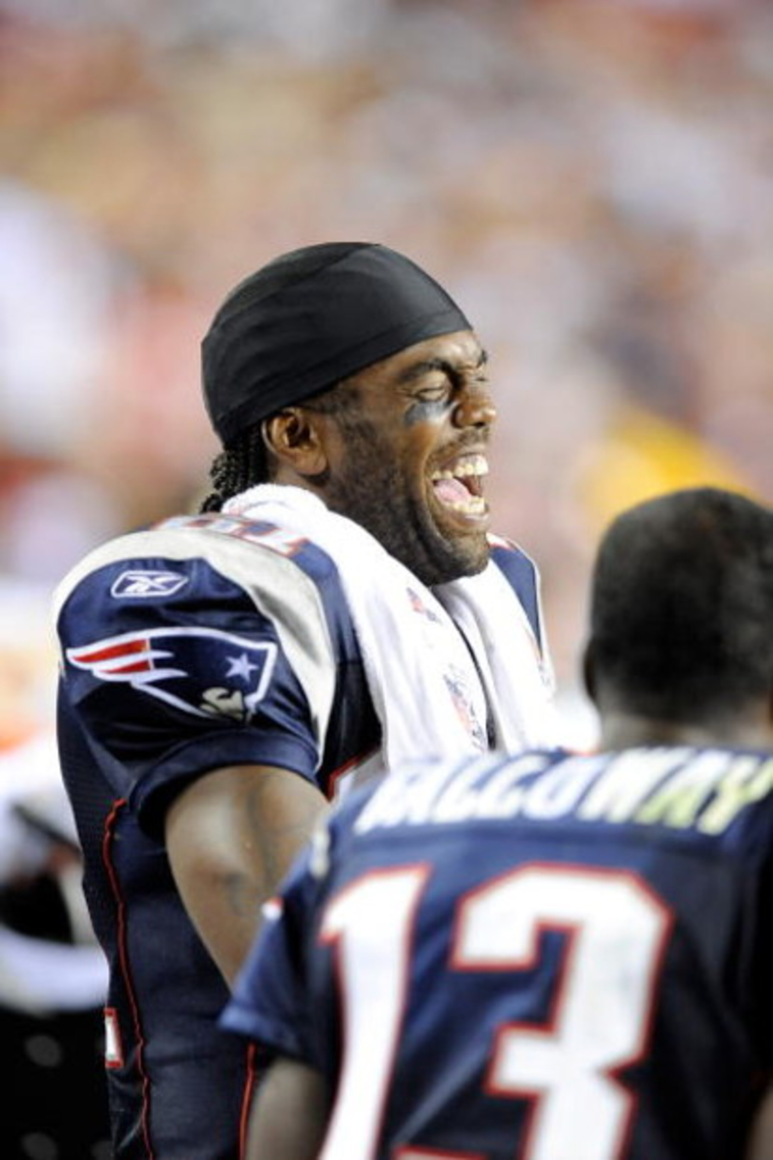 LANDOVER, MD - AUGUST 28:  Randy Moss #81 of the New England Patriots laughs with teammates while on the sideline during a preseason game against the Washington Redskins at FedExField on August 28, 2009 in Landover, Maryland.  (Photo by Greg Fiume/Getty I