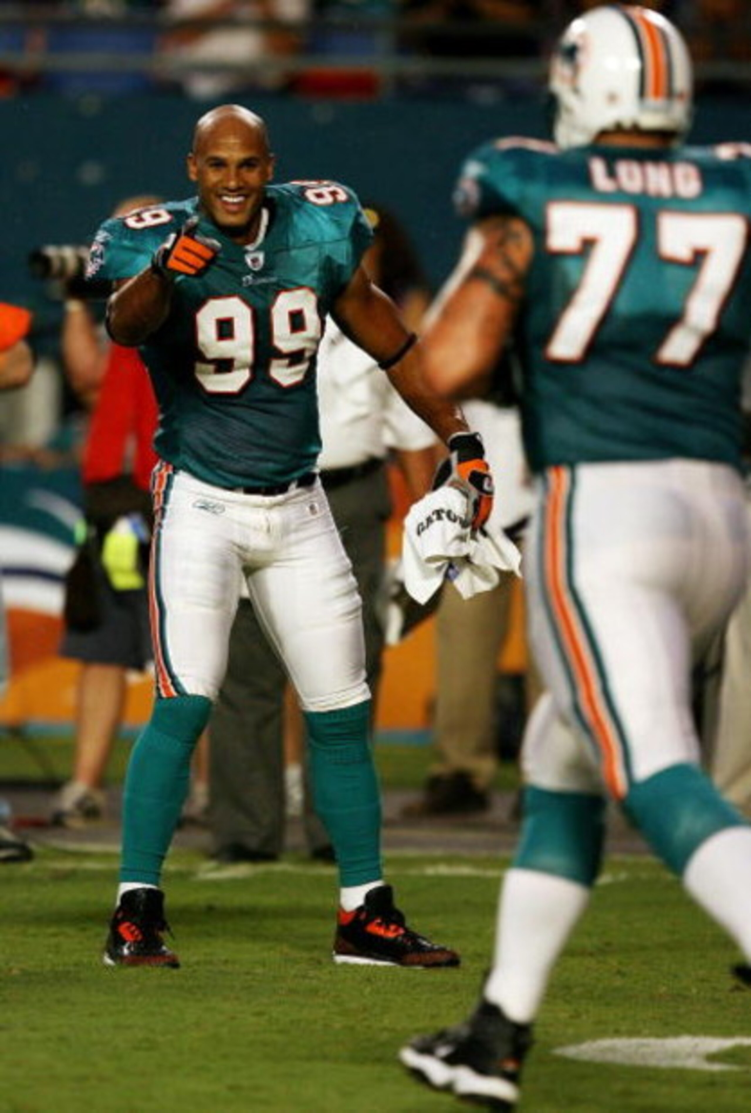 MIAMI - AUGUST 22:  Linebacker Jason Taylor #99 of the Miami Dolphins celebrates as he points to offensive lineman Jake Long #77 after a scoring drive against the Carolina Panthers during a pre-season game at Land Shark Stadium on August 22, 2009 in Miami