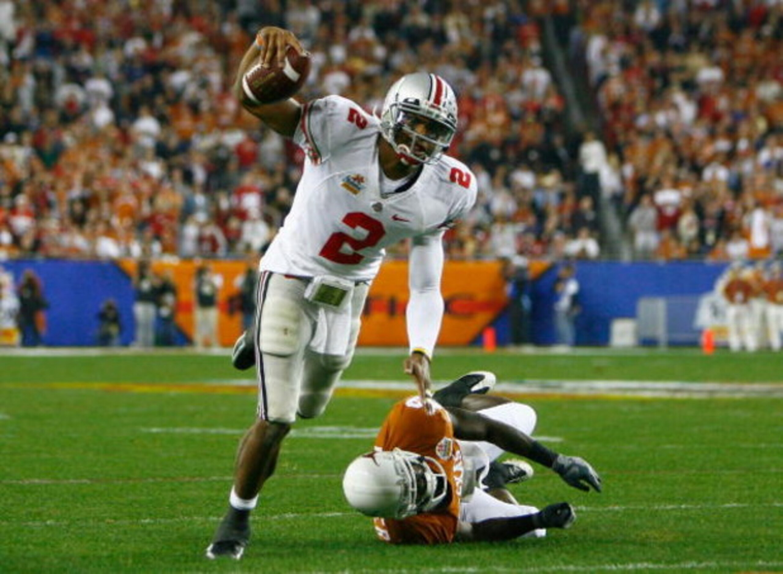 GLENDALE, AZ - JANUARY 05:  Quarterback Terrelle Pryor #2 of the Ohio State Buckeyes scrambles with the ball under pressure from Ryan Palmer #13 of the Texas Longhorns during the Tostitos Fiesta Bowl Game on January 5, 2009 at University of Phoenix Stadiu