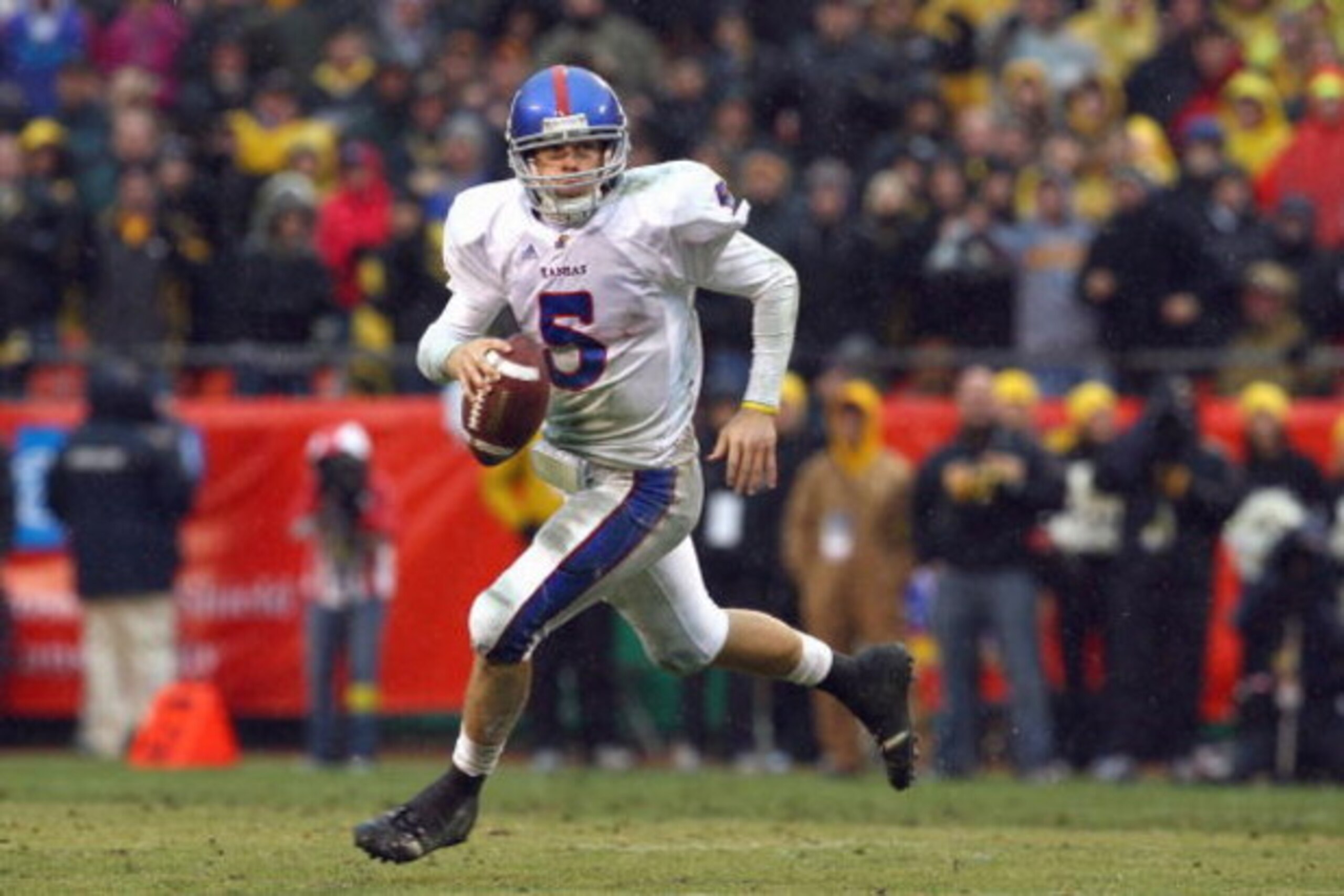 KANSAS CITY, MO - NOVEMBER 29:  Quarterback Todd Reesing #5of the Kansas Jayhawks runs to pass the ball during the game against the Missouri Tigers on November 29, 2008 at Arrowhead Stadium in Kansas City, Missouri. (Photo by Jamie Squire/Getty Images)