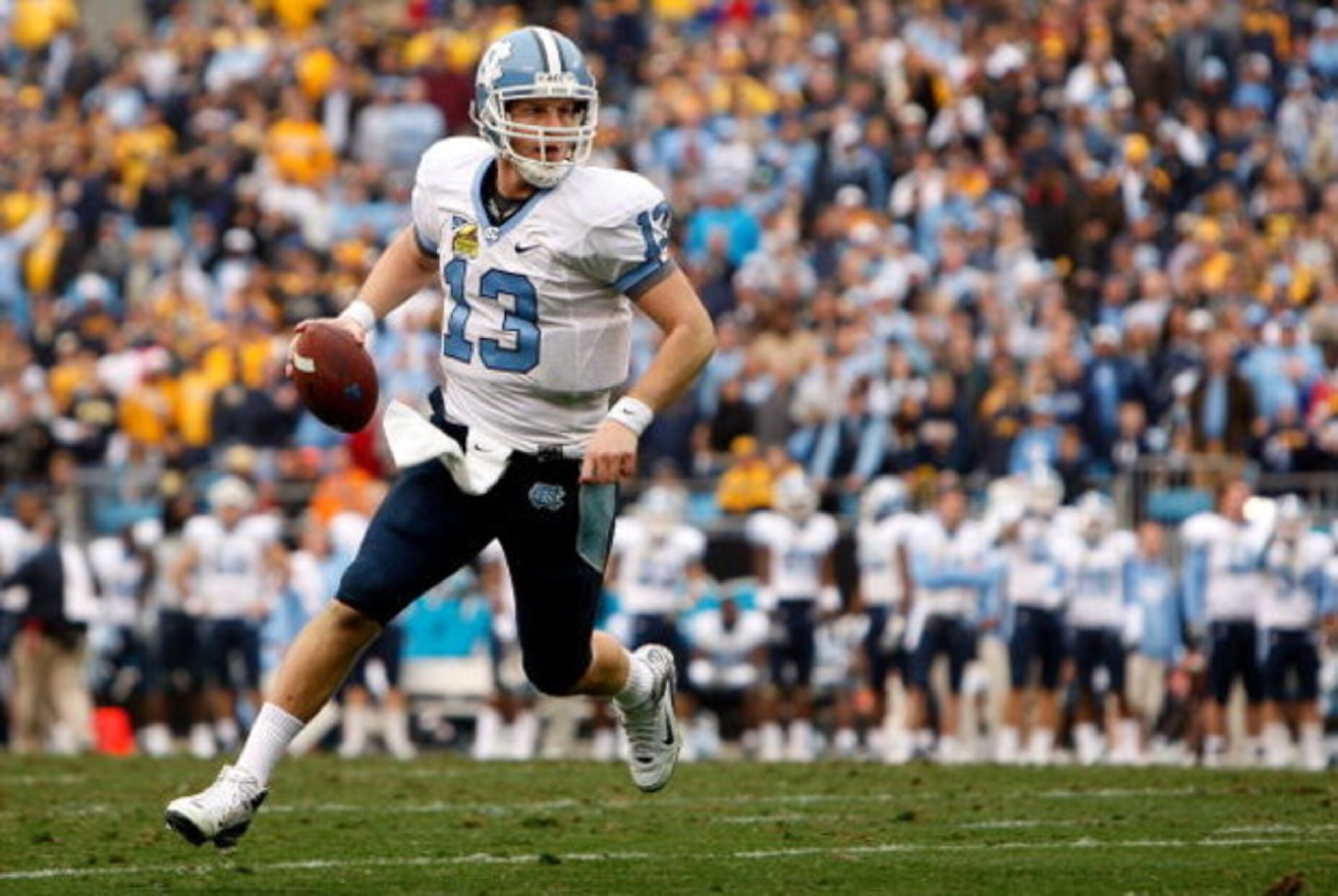 CHARLOTTE, NC - DECEMBER 27:  T.J. Yates #13 of the North Carolina Tar Heels runs with the ball against the West Virginia Mountaineers during the Meineke Car Care Bowl on December 27, 2008 at Bank of America Stadium in Charlotte, North Carolina.  (Photo b