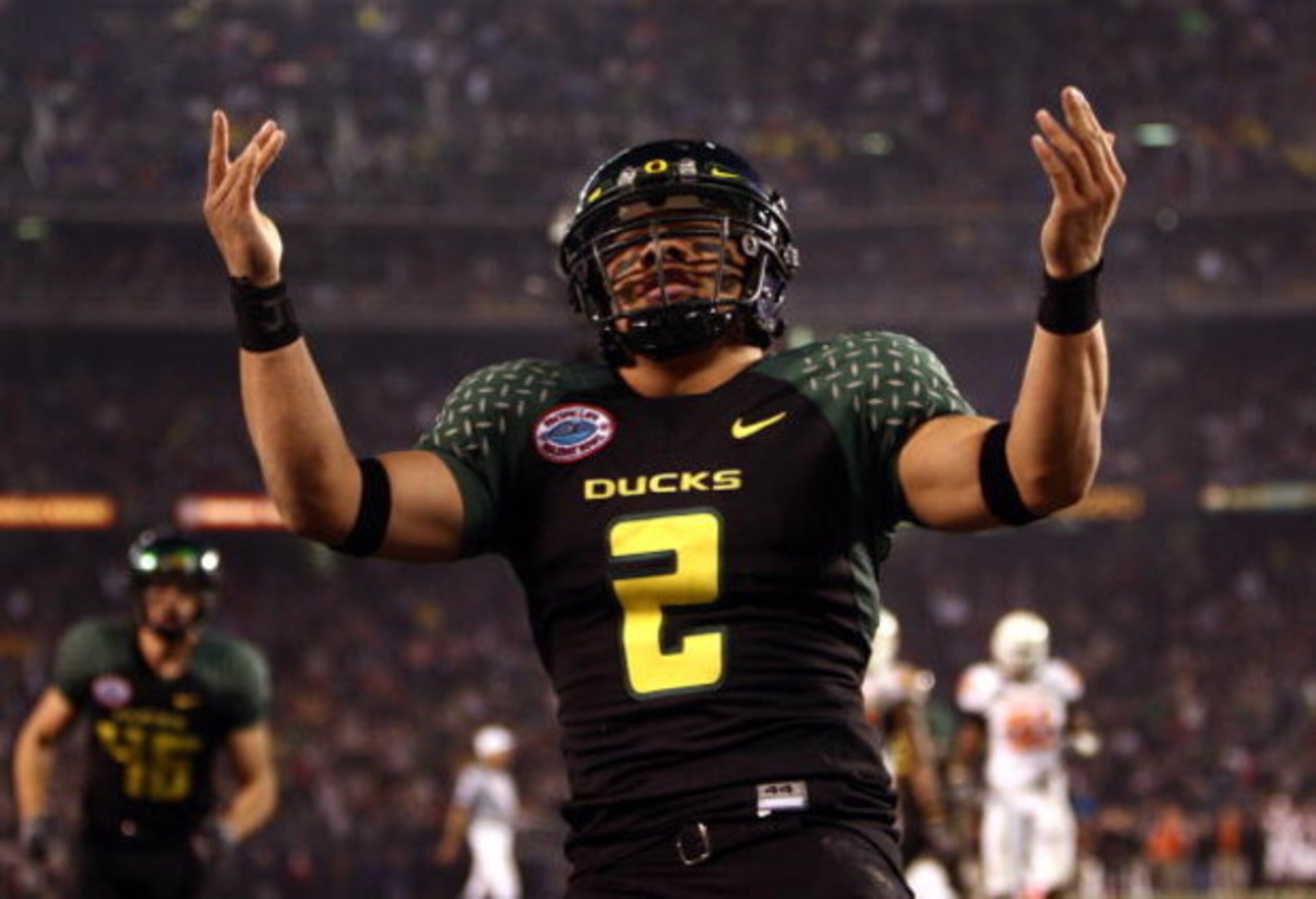 SAN DIEGO, CA - DECEMBER 30:   Quarterback Jeremiah Masoli #2 of the University of Oregon Ducks runs into the endzone for a touchdown against the Oklahoma State University Cowboys during the Pacific Life Holiday Bowl at Qualcomm Stadium on December 30, 20