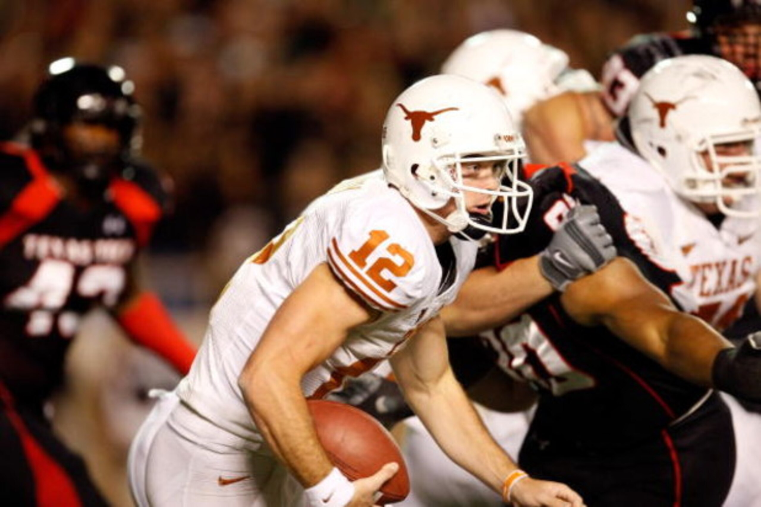LUBBOCK, TX - NOVEMBER 01:  Quarterback Colt McCoy #12 of the Texas Longhorns scrambles during the first half of the game against the Texas Tech Red Raiders on November 1, 2008 at Jones Stadium in Lubbock, Texas.  (Photo by Jamie Squire/Getty Images)