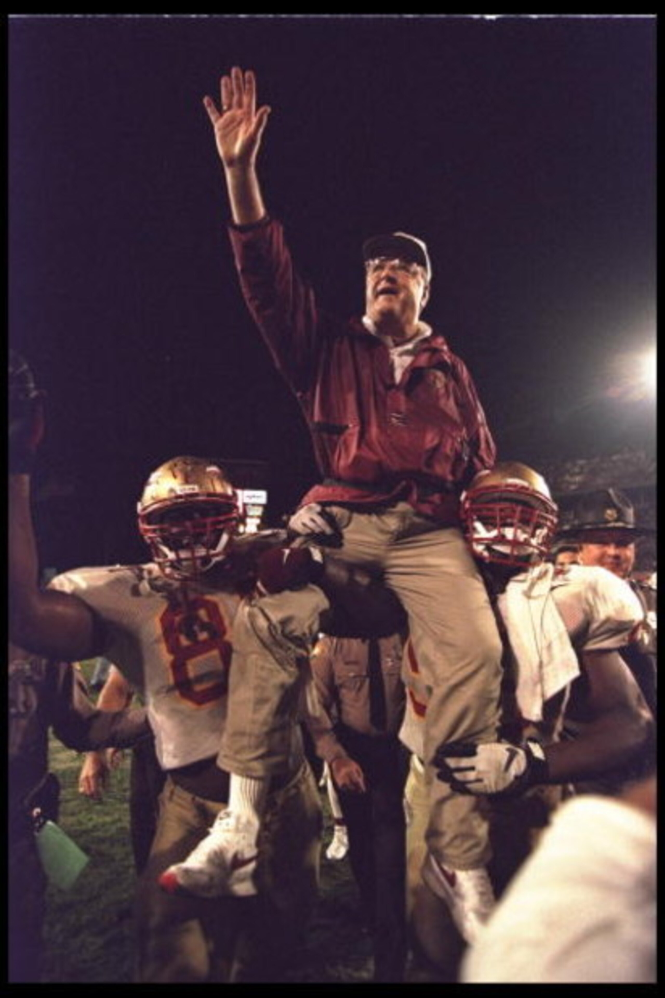 1 Jan 1996:  Head coach Bobby Bowden of the Florida State Seminoles is carried triumphantly off the field by nose guard Andre Wadsworth #8 and tackle Orpheus Roy after defeating the Notre Dame Fighting Irish in the Orange Bowl in Miami, Florida 31-26.  Ma