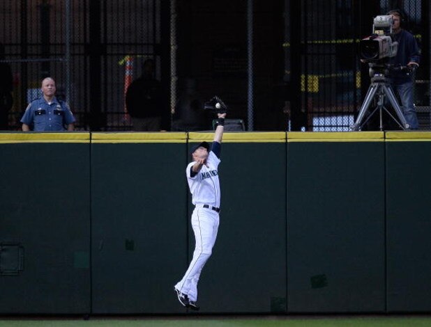 SEATTLE - AUGUST 25:  Left fielder Michael Saunders #55 of the Seattle Mariners makes a leaping catch in the second inning against the Oakland Athletics on August 25, 2009 at Safeco Field in Seattle, Washington. (Photo by Otto Greule Jr/Getty Images)