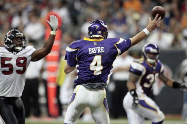 HOUSTON - AUGUST 31:  Quarterback Brett Favre #4 of the Minnesota Vikings releases a pass as he is pressured by linebacker DeMeco Ryans #59 of the Houston Texans at Reliant Stadium on August 31, 2009 in Houston, Texas.  (Photo by Bob Levey/Getty Images)
