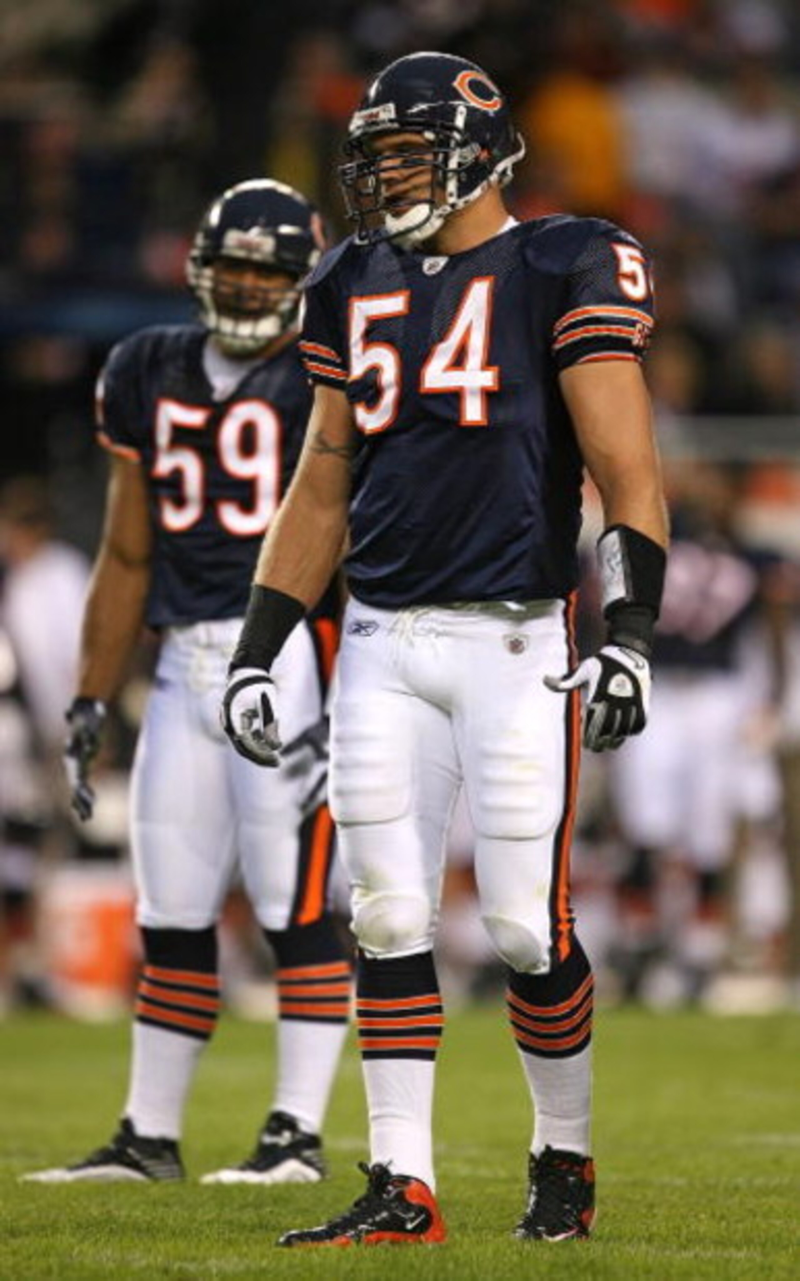 CHICAGO - AUGUST 22: Brian Urlacher #54 and Pisa Tinoisamoa #59 of the Chicago Bears wait for the start of play against the New York Giants during a pre-season game on August 22, 2009 at Soldier Field in Chicago, Illinois. The Bears defeated the Giants 17