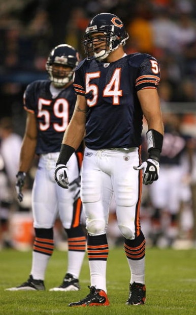 CHICAGO - AUGUST 22: Brian Urlacher #54 and Pisa Tinoisamoa #59 of the Chicago Bears wait for the start of play against the New York Giants during a pre-season game on August 22, 2009 at Soldier Field in Chicago, Illinois. The Bears defeated the Giants 17