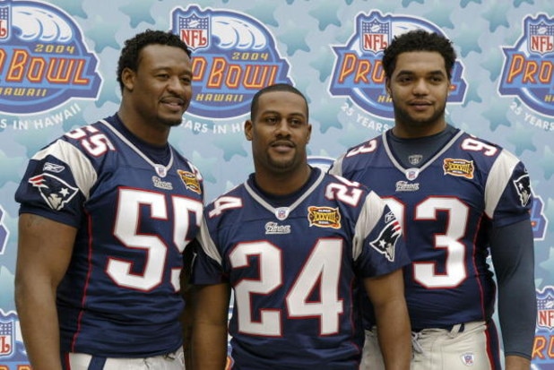 HOUSTON - JANUARY 27:  Pro Bowl selections defensive end Willie McGinest #55, cornerback Ty Law #24, defensive lineman Richard Seymour #93 of the New England Patriots pose for a photo on media day January 27, 2003 at Reliant Stadium before Super Bowl XXXV