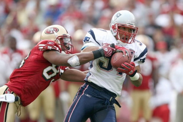 SAN FRANCISCO - OCTOBER 5:  Rodney Harrison #37 of the New England Patriots grips the ball as he is grabbed by Arnaz Battle #83 of the San Francisco 49ers during an NFL game on October 5, 2008 at Monster Park in San Francisco, California. 