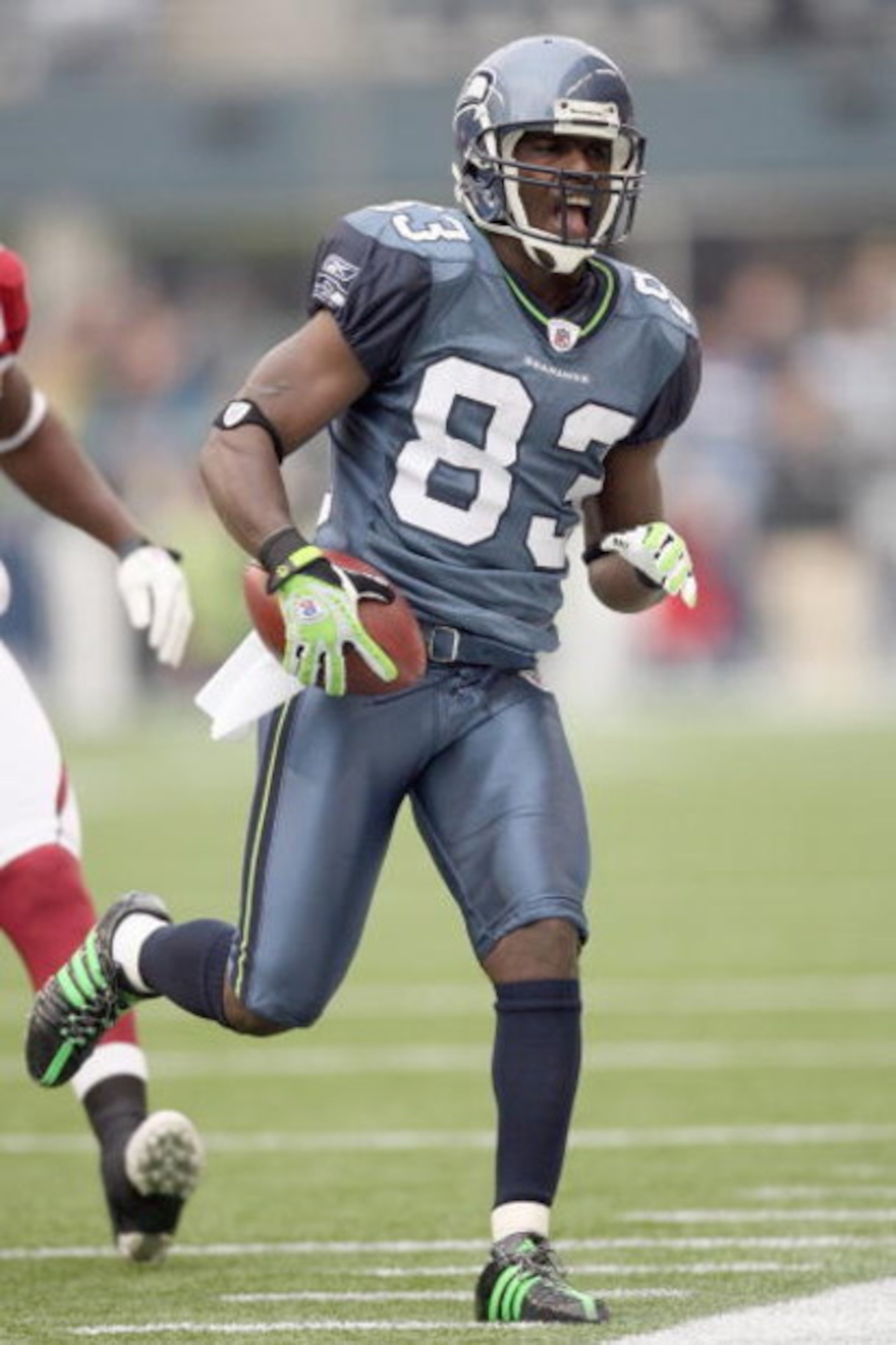 SEATTLE - NOVEMBER 16:  Deion Branch #83 of the Seattle Seahawks reacts as he runs the ball during the game against the Arizona Cardinals on November 16, 2008 at Qwest Field in Seattle, Washington. (Photo by Otto Greule Jr/Getty Images)