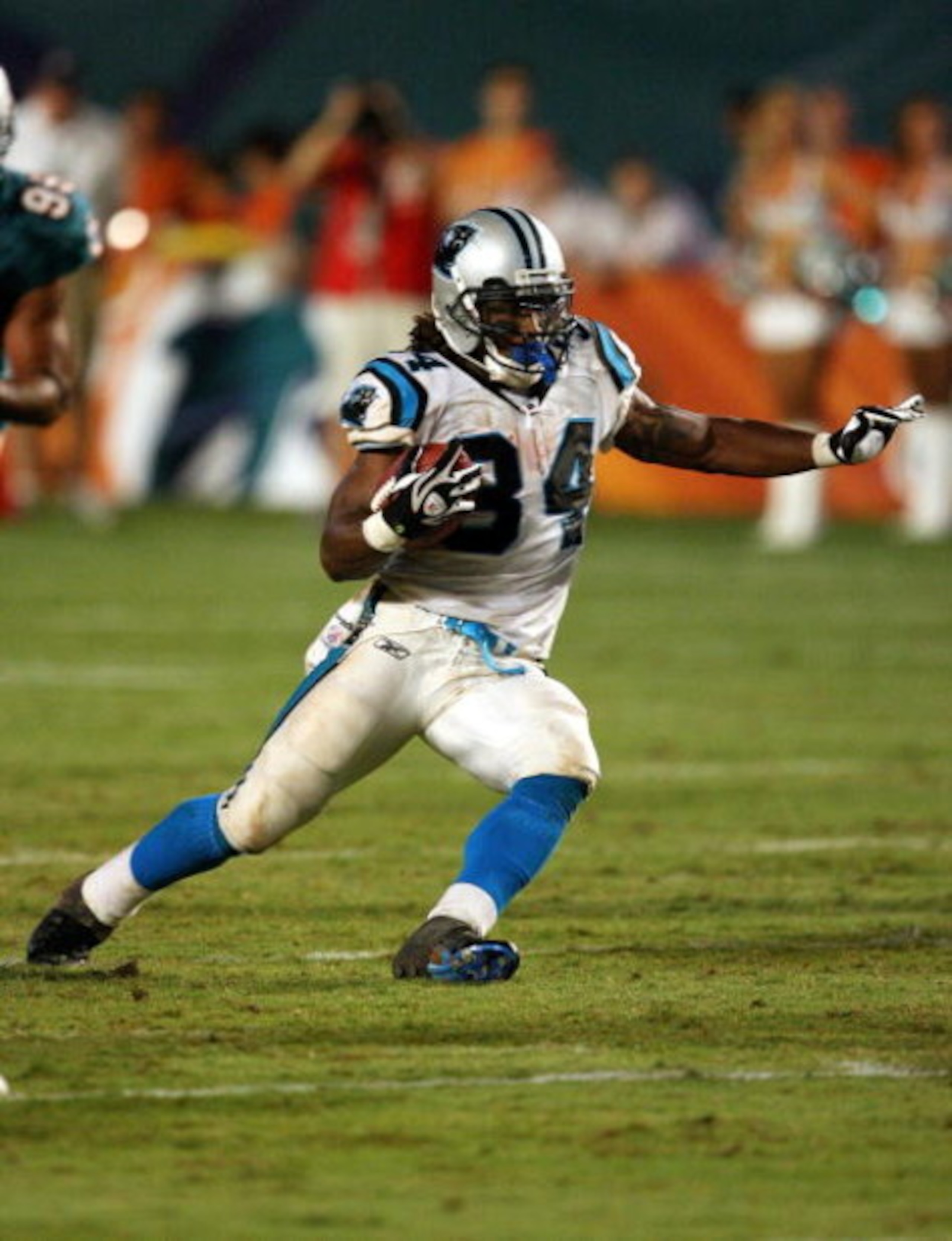 MIAMI - AUGUST 22:  Running back DeAngelo Williams #34 of the Carolina Panthers looks for room to run against the Miami Dolphins during a pre-season game at Land Shark Stadium on August 22, 2009 in Miami, Florida. The Dolphins defeated the Panthers 27-17.