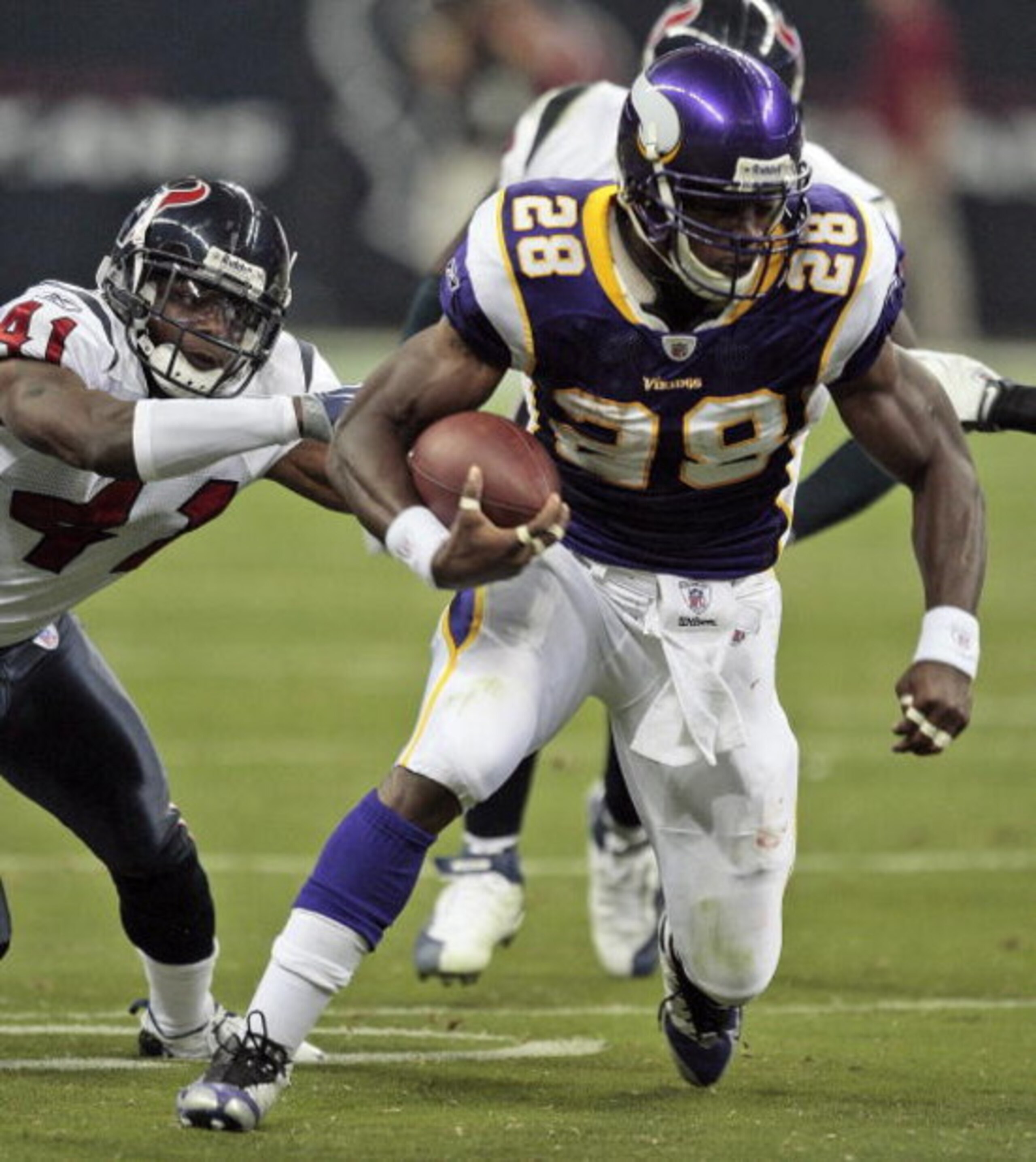 HOUSTON - AUGUST 31:  Running back Adrian Peterson #28 of the Minnesota Vikings breaks a tackle by cornerback Brice McCain #41 of the Houston Texans at Reliant Stadium on August 31, 2009 in Houston, Texas.  (Photo by Bob Levey/Getty Images)