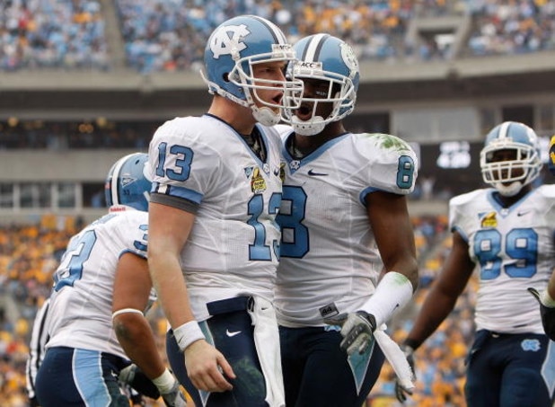 CHARLOTTE, NC - DECEMBER 27:  T.J. Yates #13 of the North Carolina Tar Heels celebrates with teammate Greg Little #8 after Yates scored a touchdown against the West Virginia Mountaineers during the Meineke Car Care Bowl on December 27, 2008 at Bank of Ame
