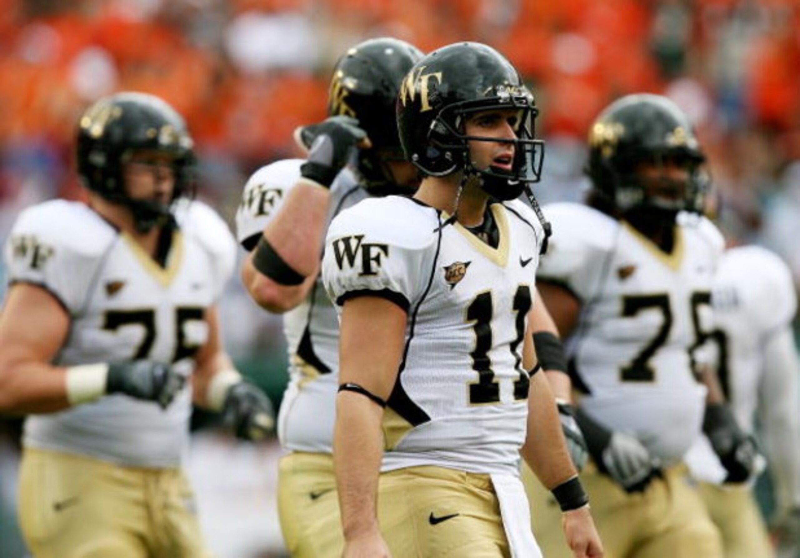 MIAMI - OCTOBER 25: Quarterback Riley Skinner #11 of the Wake Forest Demon Decons walks with the offense off the field after failing to convert on a fourth down attempt against the Miami Hurricanes at Dolphin Stadium on October 25, 2008 in Miami, Florida MIAMI - OCTOBER 25: Quarterback Riley Skinner #11 of the Wake Forest Demon Decons walks with the offense off the field after failing to convert on a fourth down attempt against the Miami Hurricanes at Dolphin Stadium on October 25, 2008 in Miami, Florida