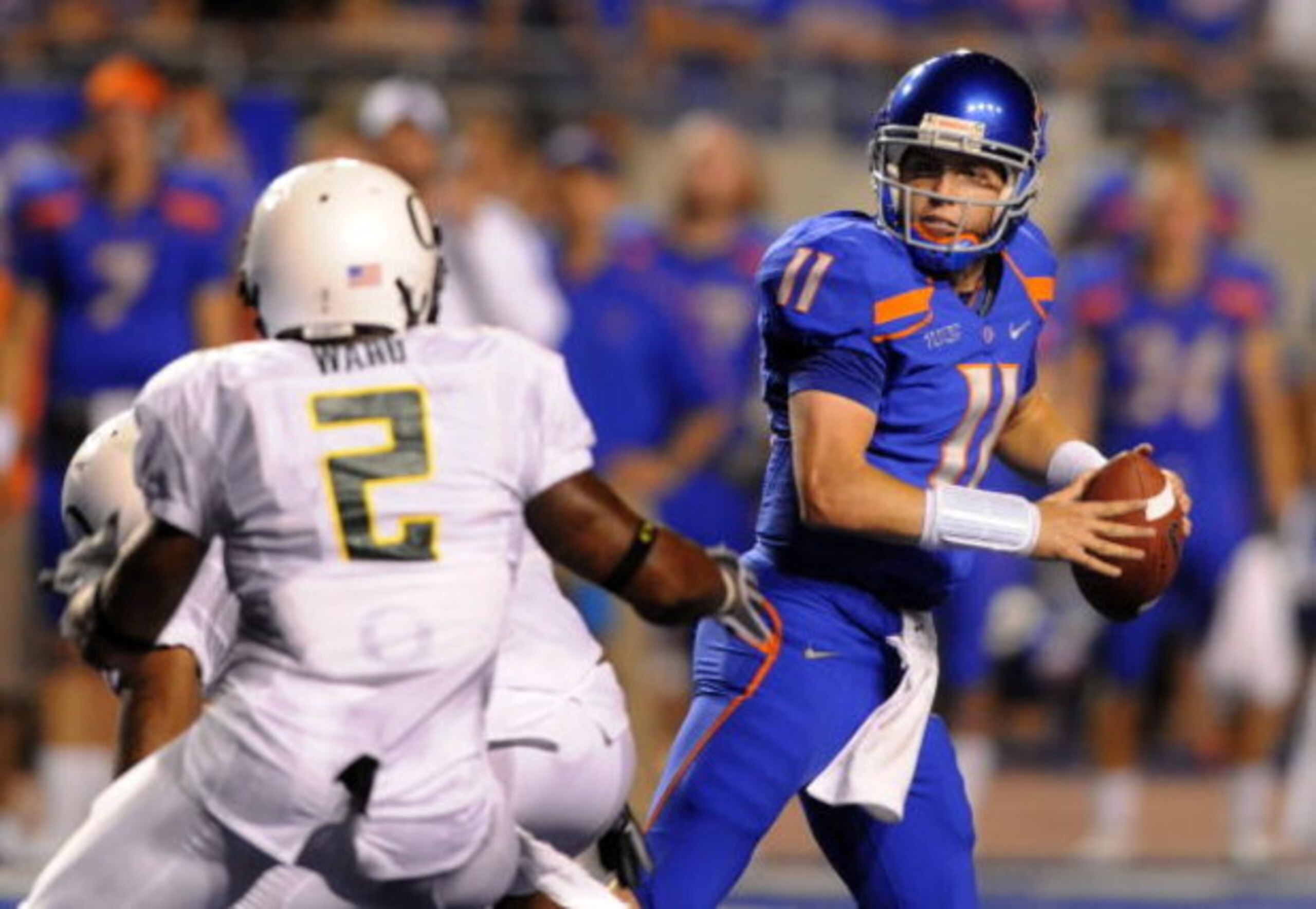 BOISE, ID - SEPTEMBER 3: Kellen Moore #11 of the Boise State throws a pass under pressure by T.J. Ward #2 of the Oregon Ducks in second quarter of the game on September 3, 2009 at Broncos Stadium in Boise, Idaho. Boise State won the game 19-8. (Photo by BOISE, ID - SEPTEMBER 3: Kellen Moore #11 of the Boise State throws a pass under pressure by T.J. Ward #2 of the Oregon Ducks in second quarter of the game on September 3, 2009 at Broncos Stadium in Boise, Idaho. Boise State won the game 19-8. (Photo by