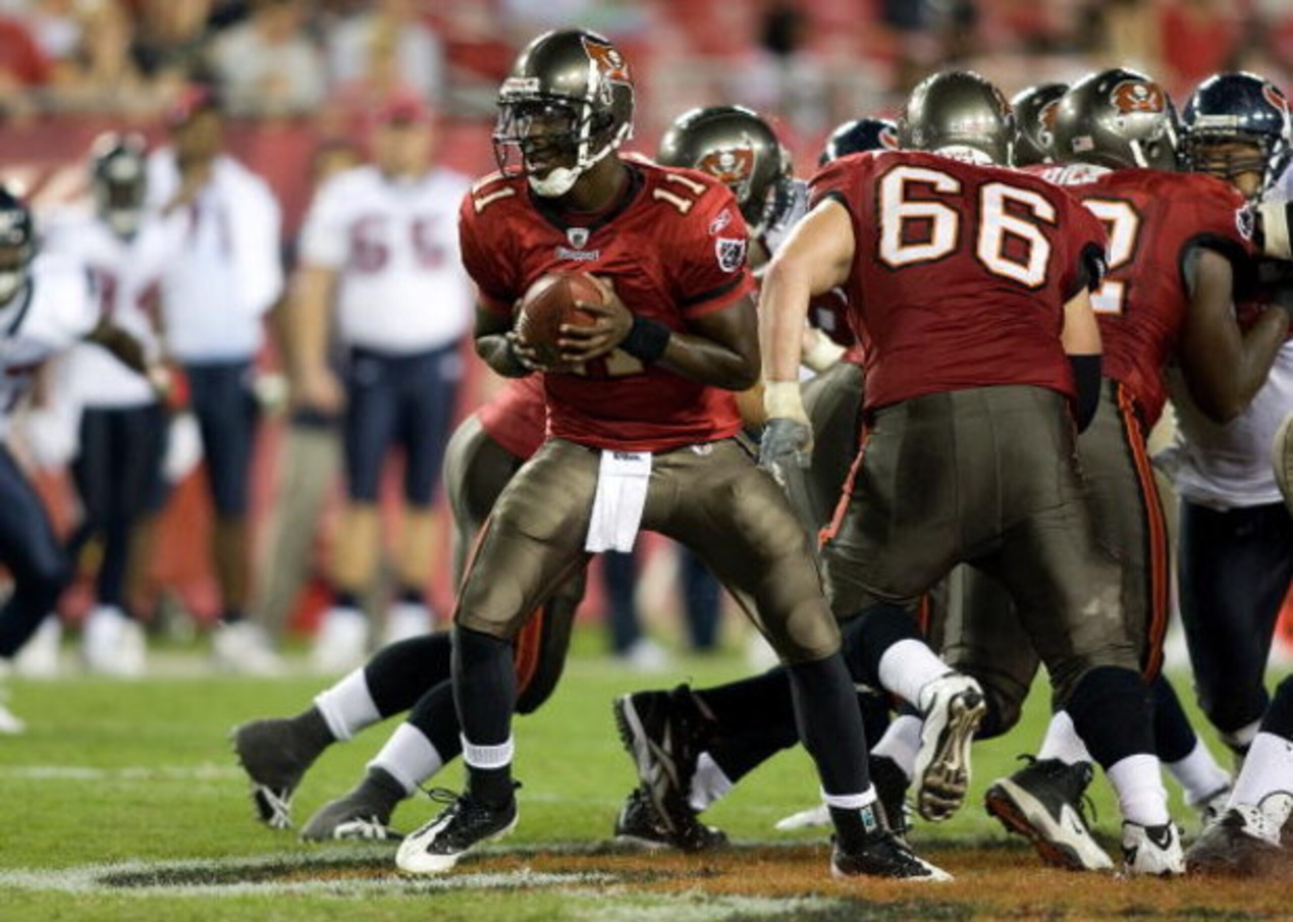 TAMPA, FL - SEPTEMBER 04:  Quarterback Josh Johnson #11 of the Tampa Bay Buccaneers hands the ball off against the Houston Texans during a preseason game at Raymond James Stadium on September 4, 2009 in Tampa, Florida.  (Photo by J. Meric/Getty Images)