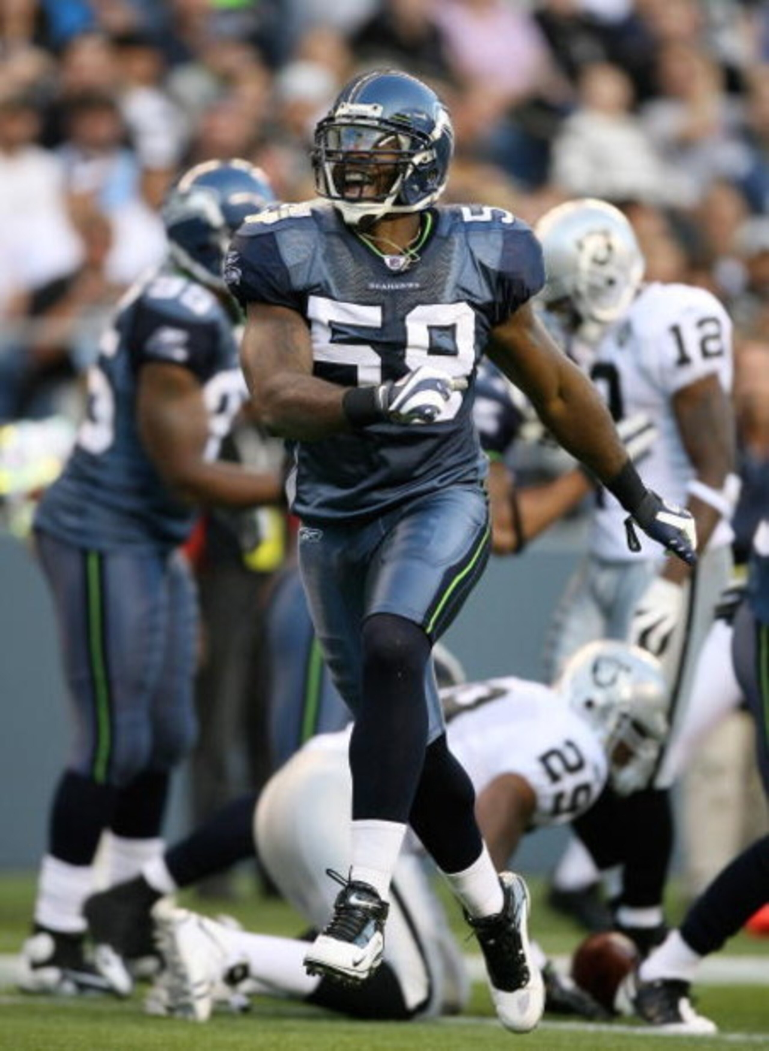 SEATTLE - SEPTEMBER 03:  Linebacker Aaron Curry #59 of the Seattle Seahawks celebrates after tackling running back Michael Bush #29 of the Oakland Raiders on September 3, 2009 at Qwest Field in Seattle, Washington. The Seahawks defeated the Raiders 31-21.