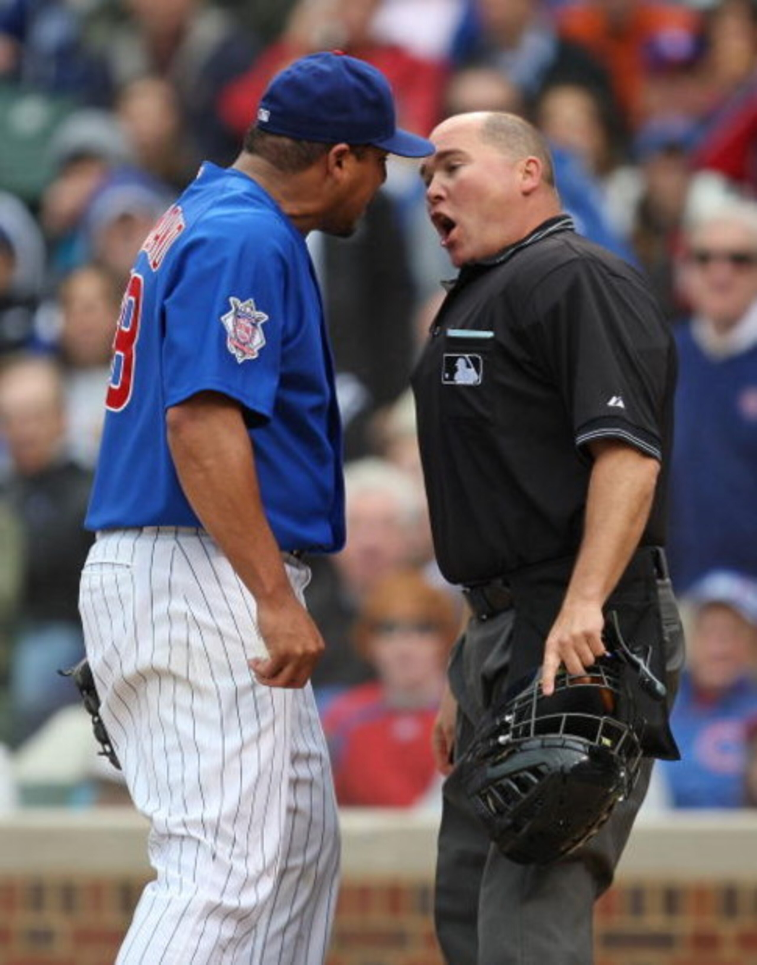 CHICAGO - MAY 27: Carlos Zambrano #38 of the Chicago Cubs argues with home plate umpire Mark Carlson #48 after a play at the plate in the 7th inning with Zambrano and Nyjer Morgan of the Pittsburgh Pirates on May 27, 2009 at Wrigley Field in Chicago, Illi