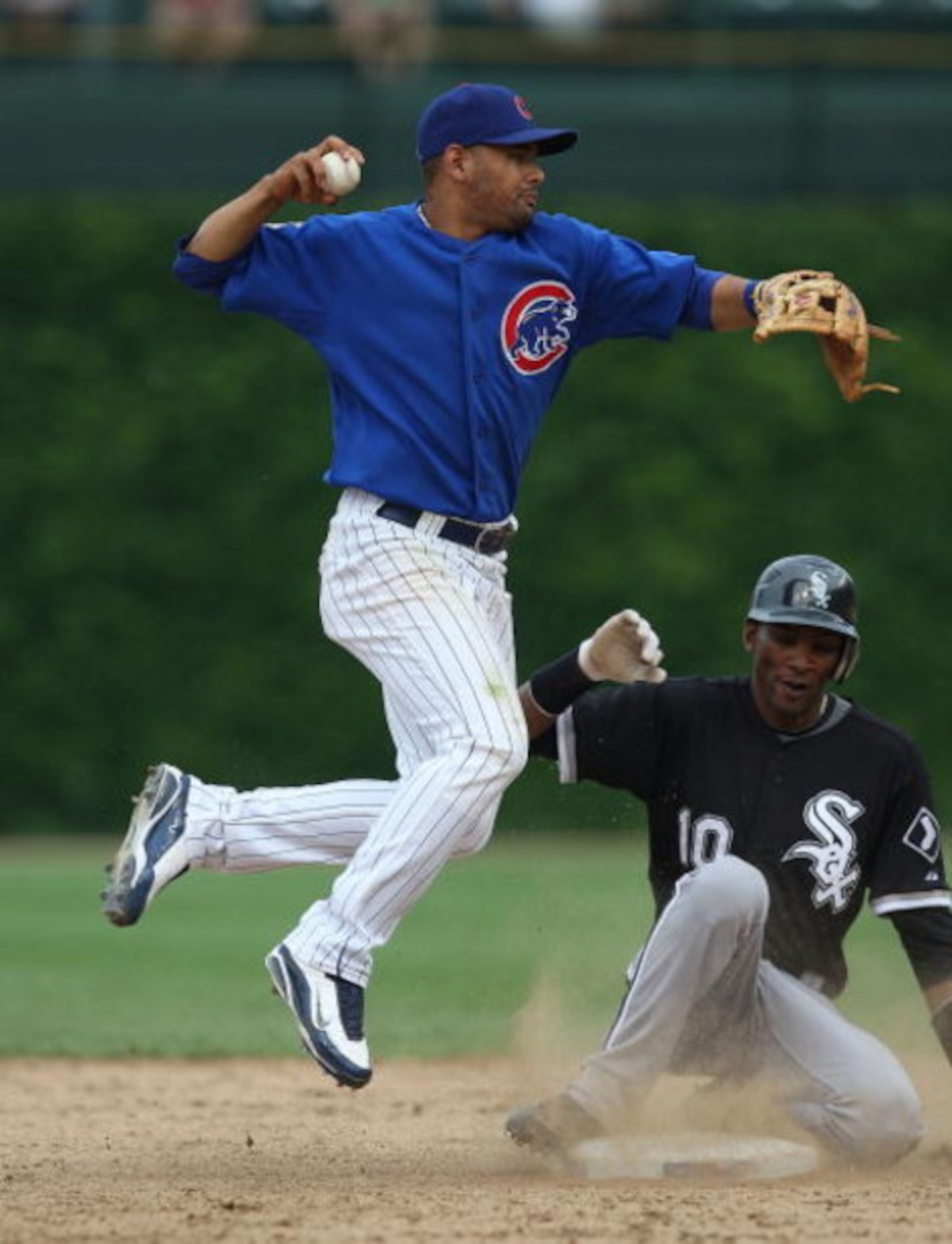 CHICAGO - JUNE 18: Alexei Ramirez #10 of the Chicago White Sox breaks up a douple play attempt by Andres Blano #13 of the Chicago Cubs on June 18, 2009 at Wrigley Field in Chicago, Illinois. The Cubs defeated the White Sox 6-5. (Photo by Jonathan Daniel/G