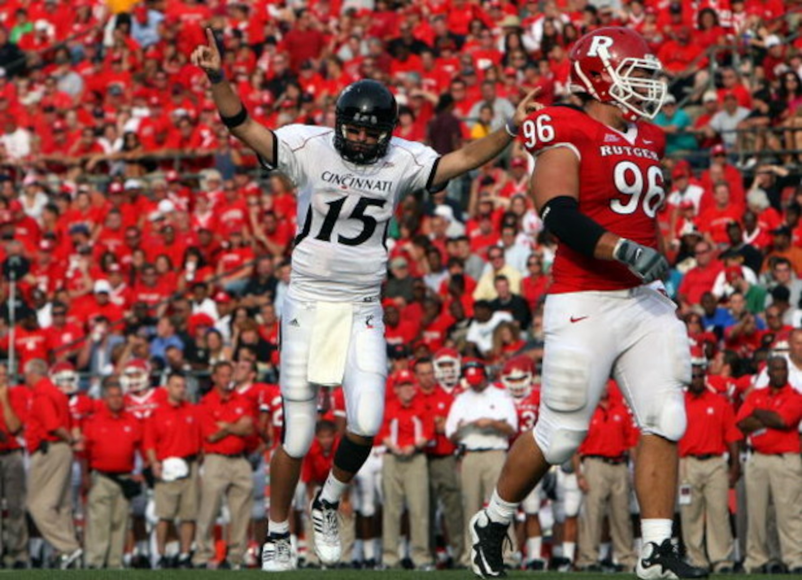 PISCATAWAY, NJ - SEPTEMBER 07:  Tony Pike #15 of the Cincinnati Bearcats celebrates a touchdown as Charlie Noonan #96 of the Rutgers Scarlet Knights looks on at Rutgers Stadium on September 7, 2009 in Piscataway, New Jersey.  (Photo by Jim McIsaac/Getty I