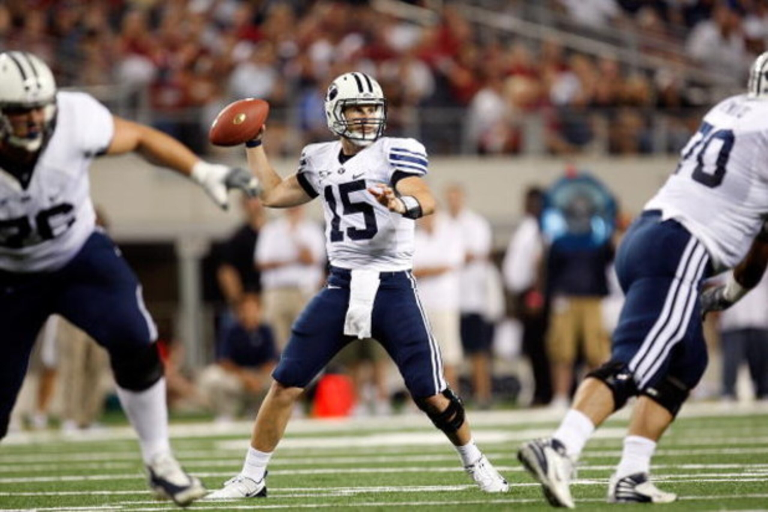 ARLINGTON, TX - SEPTEMBER 05:  Quarterback Max Hall #15 of the Brigham Young Cougars drops back to pass against the Oklahoma Sooners at Cowboys Stadium on September 5, 2009 in Arlington, Texas.  (Photo by Ronald Martinez/Getty Images)