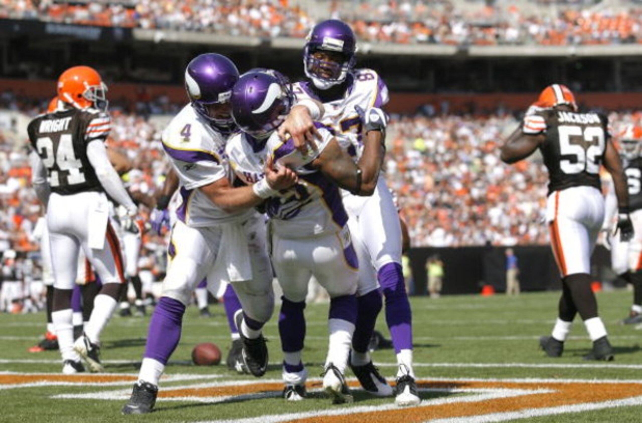 CLEVELAND - SEPTEMBER 13:  Percy Harvin #12 of the Minnesota Vikings celebrates with Brett Farve #4 and Bernard Berrian #87 after scoring a touchdown against the Cleveland Browns at Cleveland Browns Stadium on September 13, 2009 in Cleveland, Ohio.  (Phot