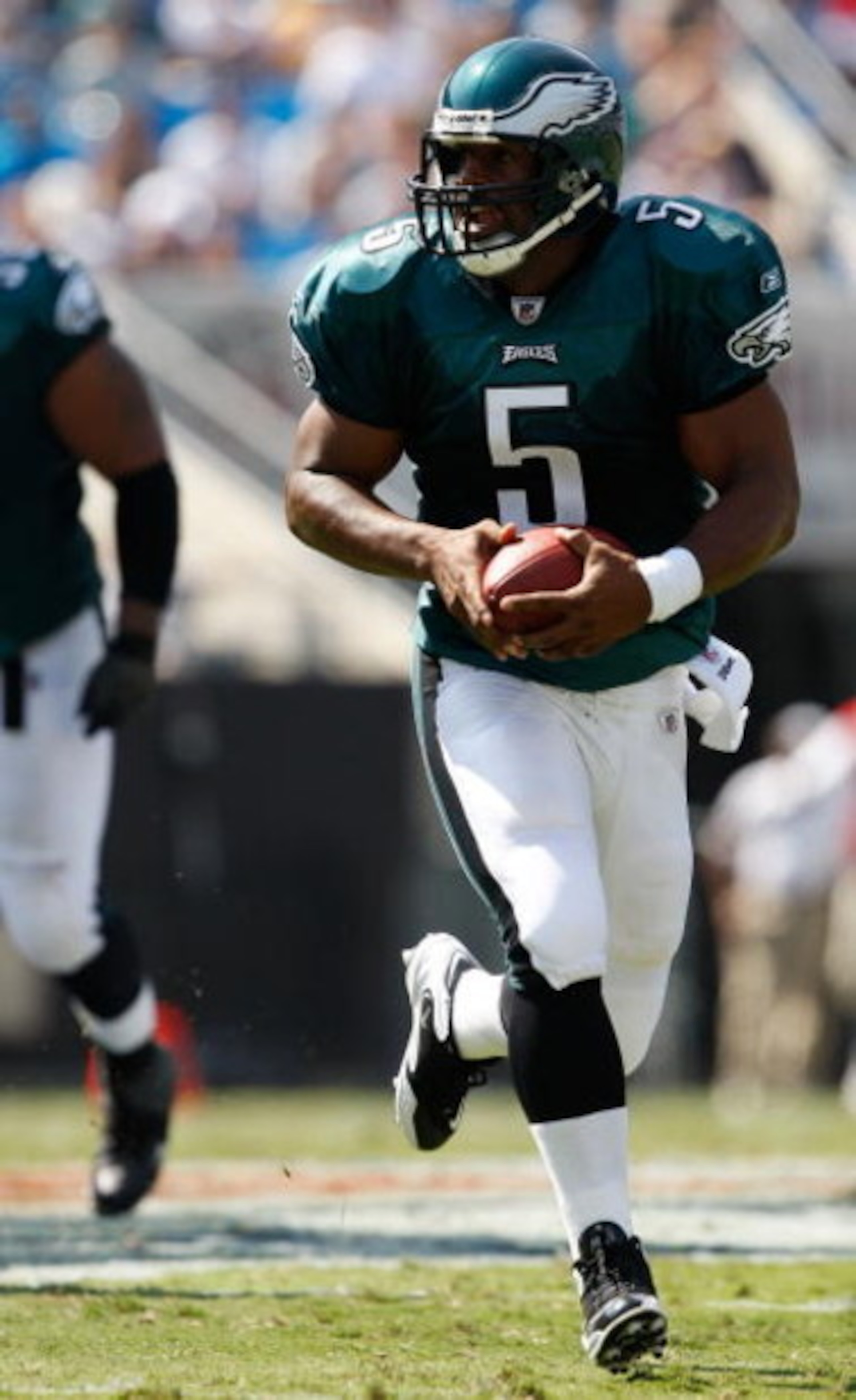 CHARLOTTE, NC - SEPTEMBER 13:  Quarterback Donovan McNabb #5 of the Philadelphia Eagles runs with the ball in the second half of their NFL season opener against the Carolina Panthers at Bank of America Stadium on September 13, 2009 in Charlotte, North Car